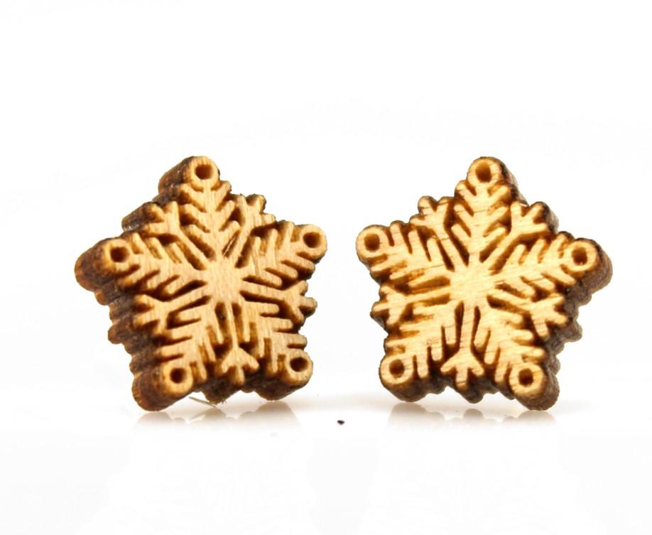 A pair of delicate snowflake stud earrings made from sustainably sourced wood, featuring a laser-cut design and silver plated brass ear studs.