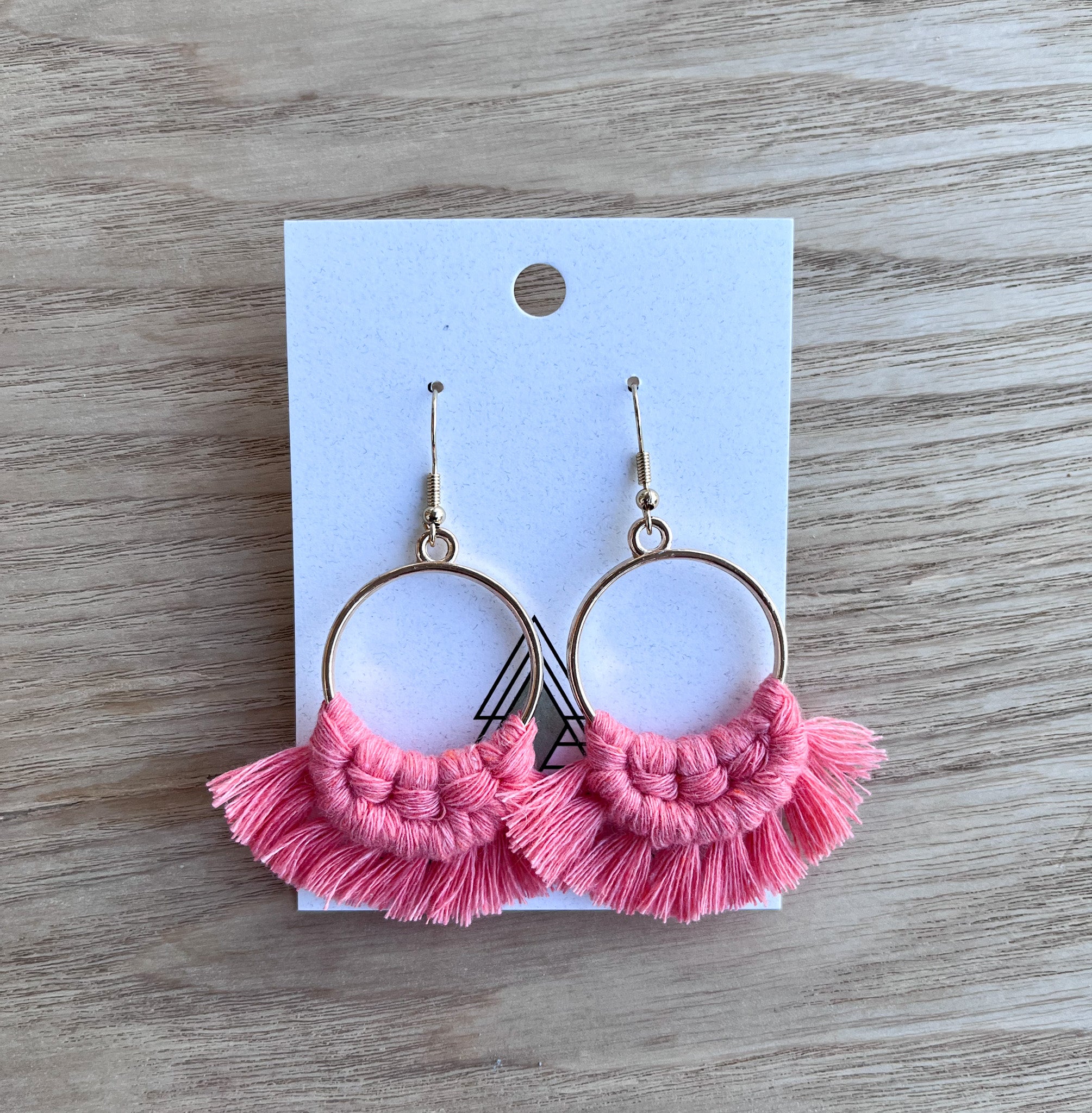 A pair of lightweight Spring Coral Rounds made from 100% cotton, showcasing a vibrant coral color, perfect for spring and summer wear.