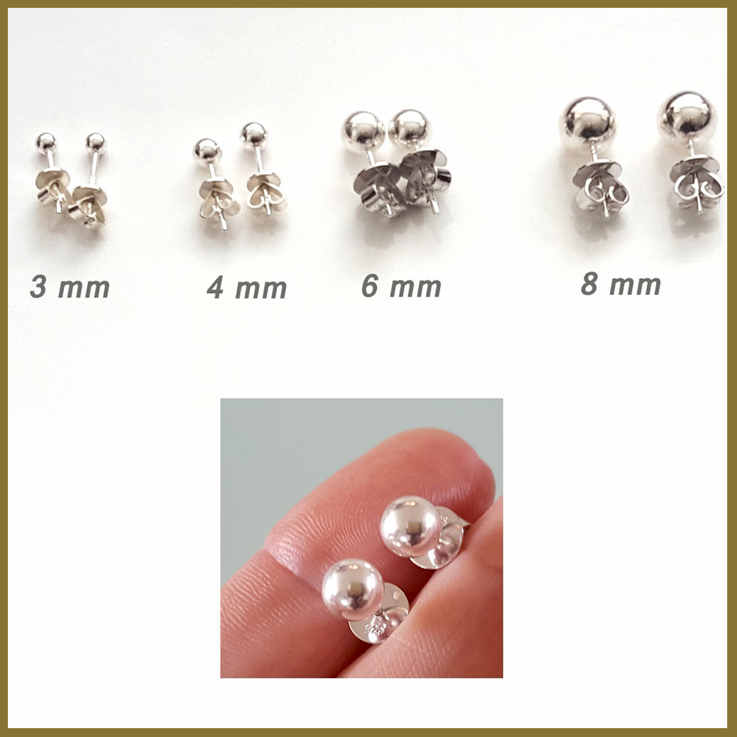 A pair of elegant sterling silver 8 mm ball stud earrings with a shiny finish, displayed on a soft fabric background.