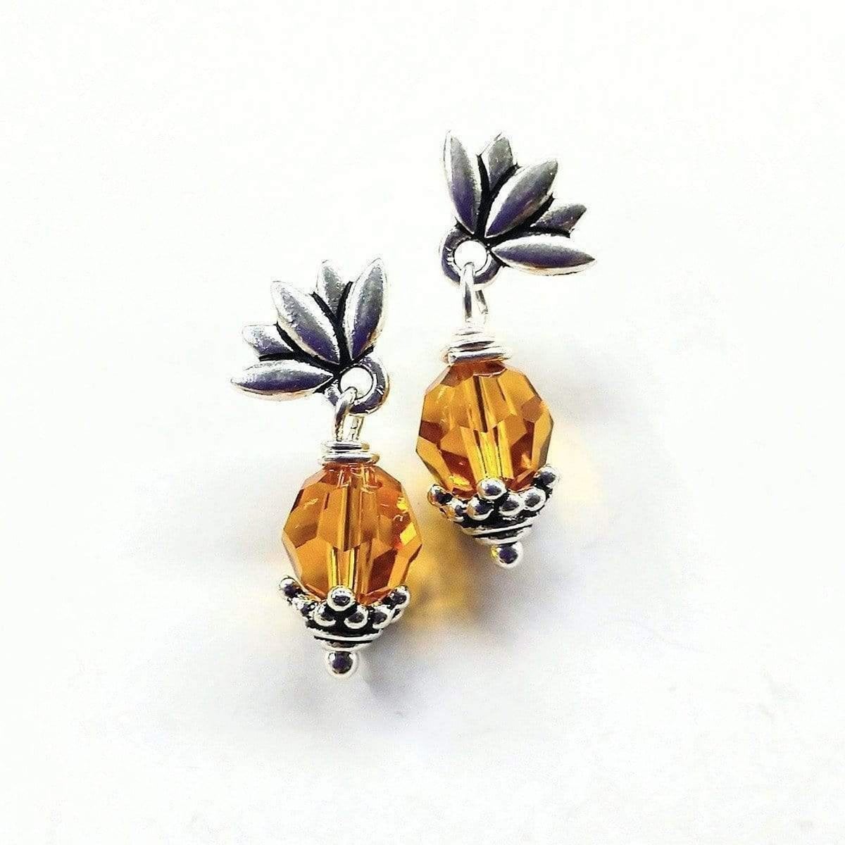 Handmade sterling silver crystal pineapple studded earrings featuring topaz Swarovski crystals and silver leafy components.