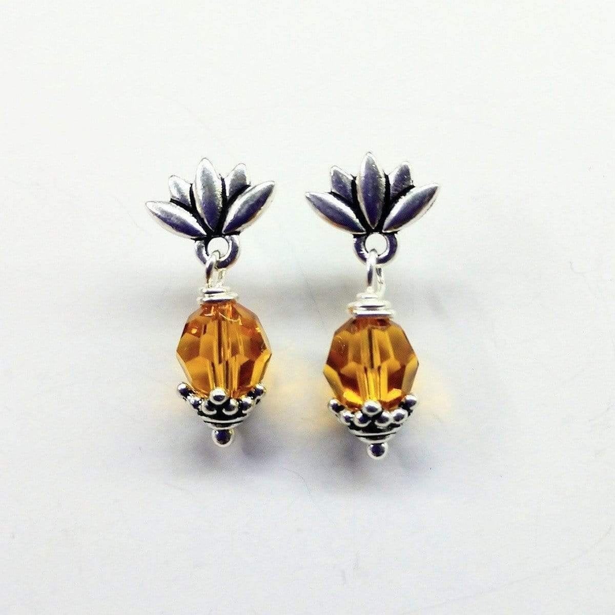 Handmade sterling silver crystal pineapple studded earrings featuring topaz Swarovski crystals and silver leafy components.