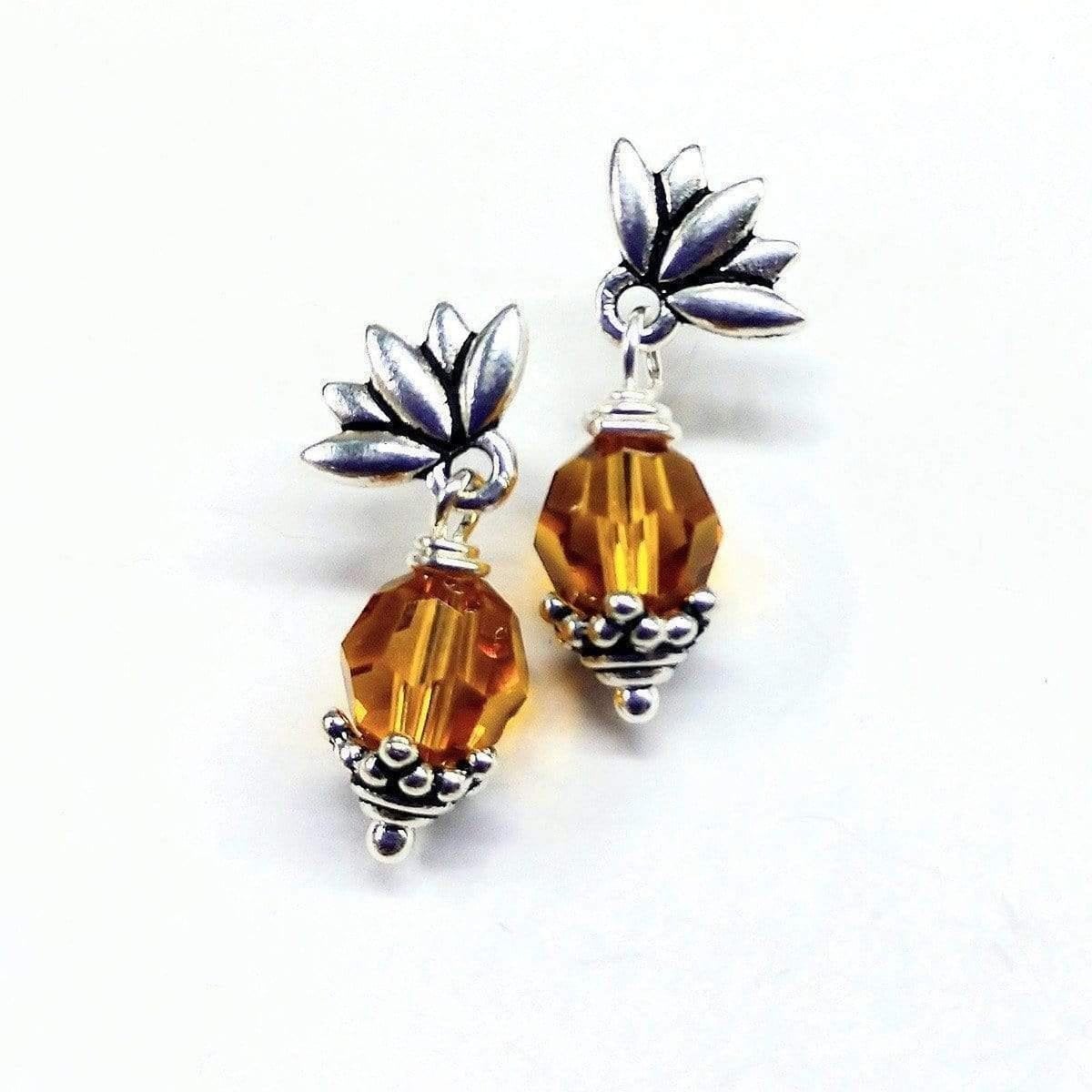 Handmade sterling silver crystal pineapple studded earrings featuring topaz Swarovski crystals and silver leafy components.