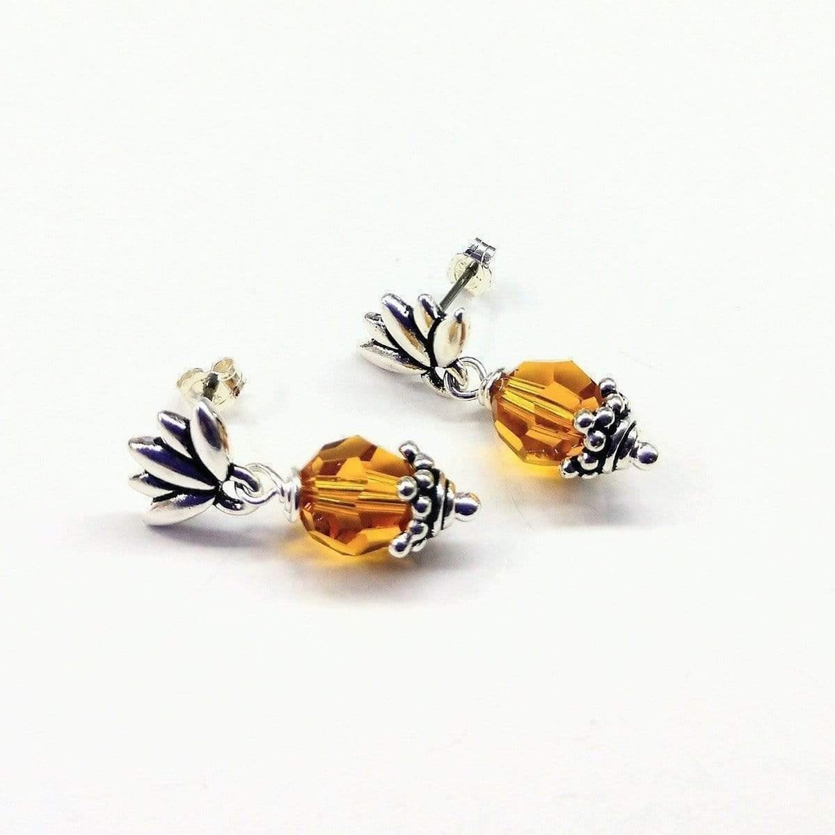 Handmade sterling silver crystal pineapple studded earrings featuring topaz Swarovski crystals and silver leafy components.