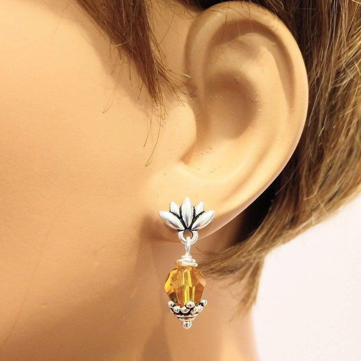 Handmade sterling silver crystal pineapple studded earrings featuring topaz Swarovski crystals and silver leafy components.