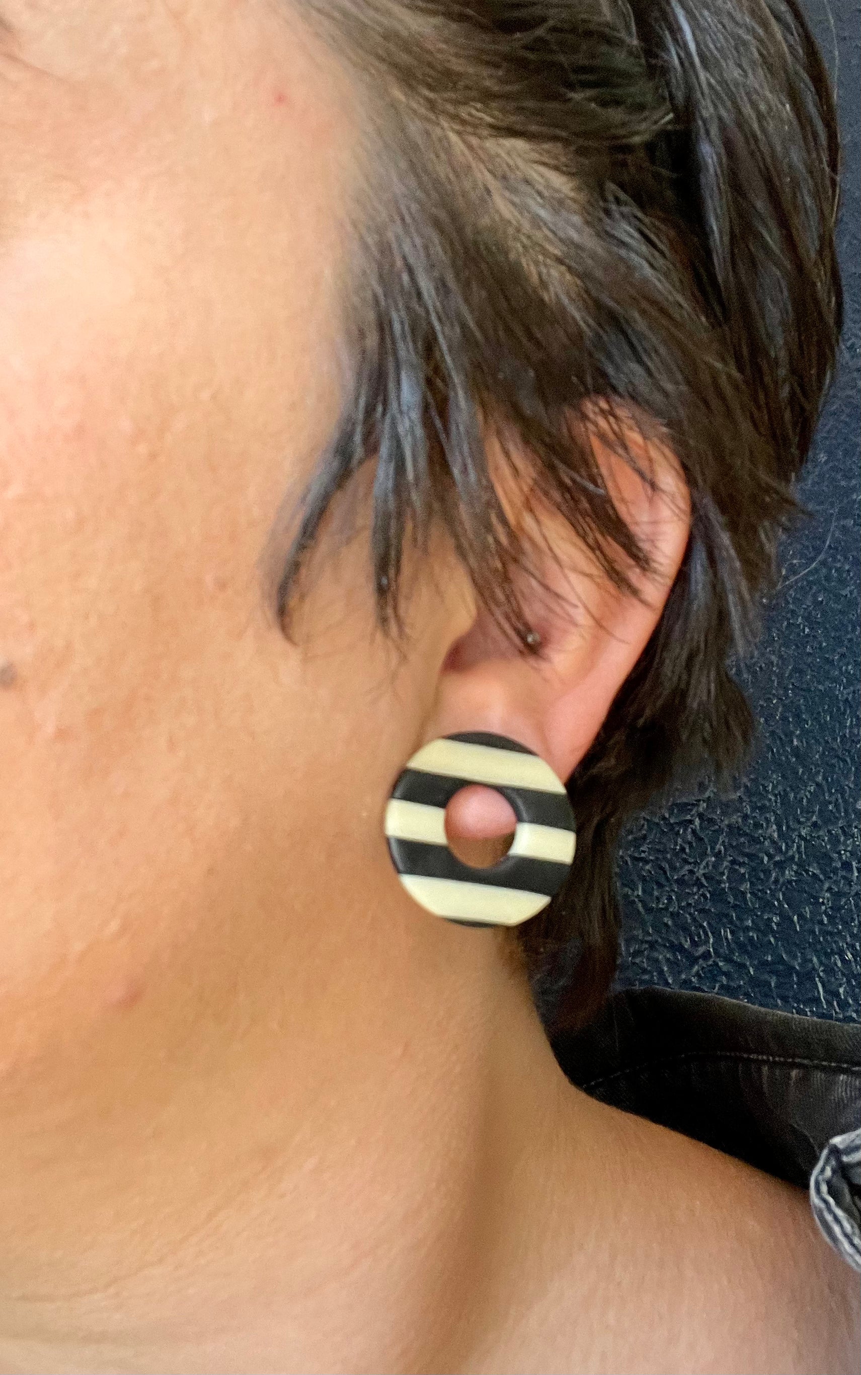 Handmade glow in the dark striped circle studs, showcasing unique patterns and colors, perfect for bold fashion statements.