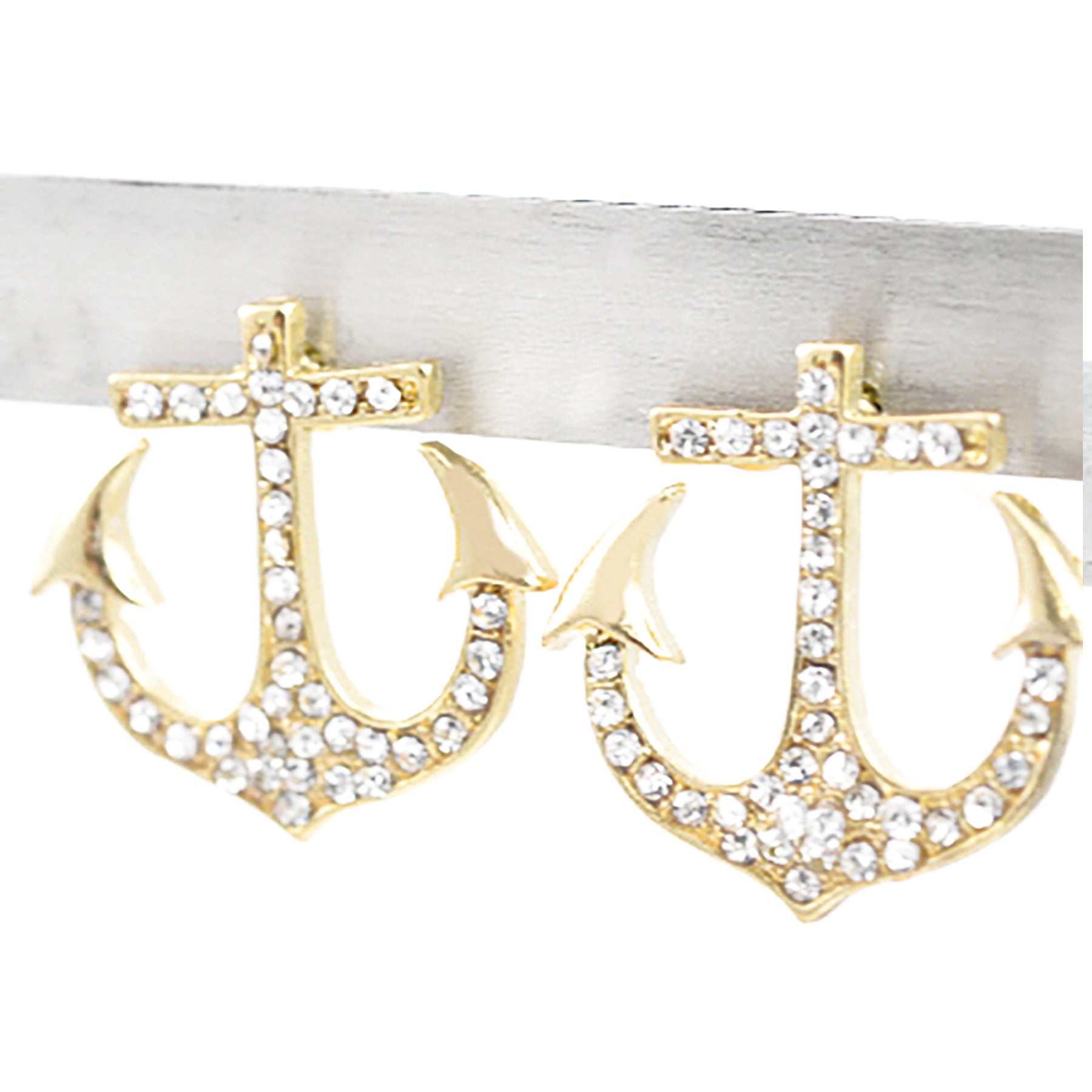 A pair of stylish studded anchor earrings with a post back, showcasing intricate detailing and a nautical theme.