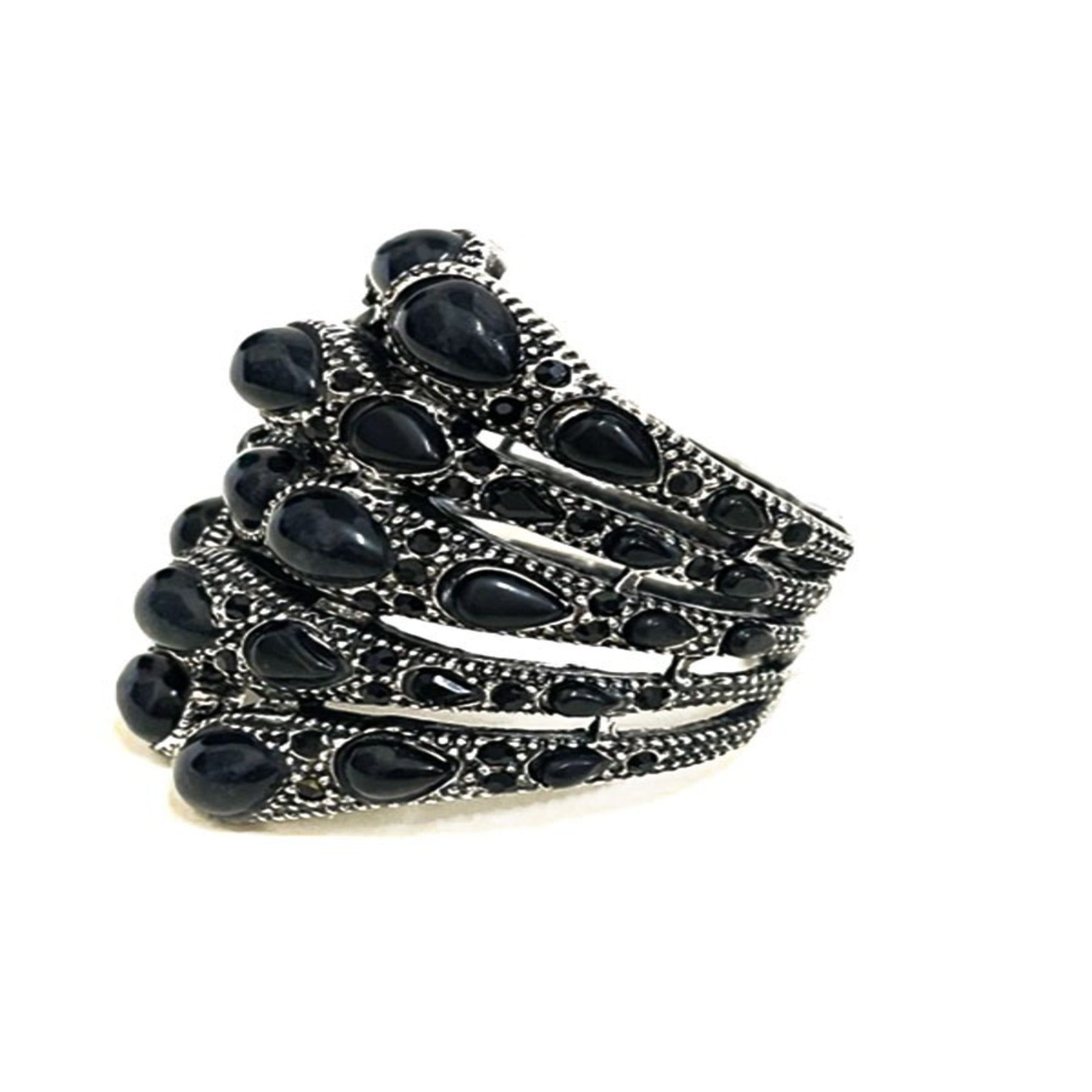 Stylish studded metal cuff bracelet with spring snap closure, showcasing a modern design perfect for any outfit.