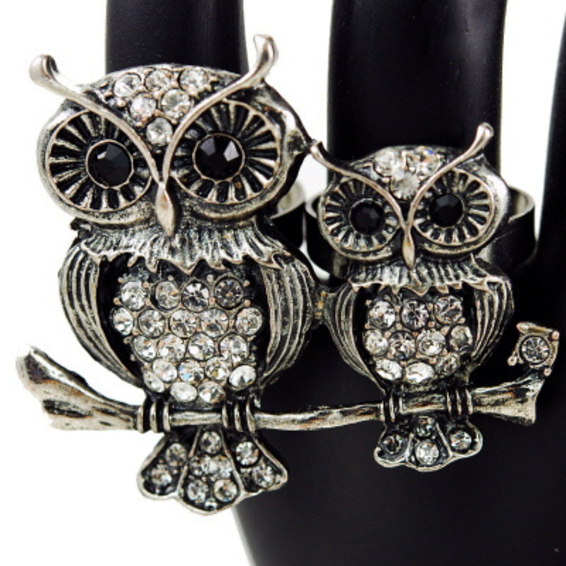 A stylish two-finger ring featuring studded owls, showcasing intricate design and unique fashion statement.