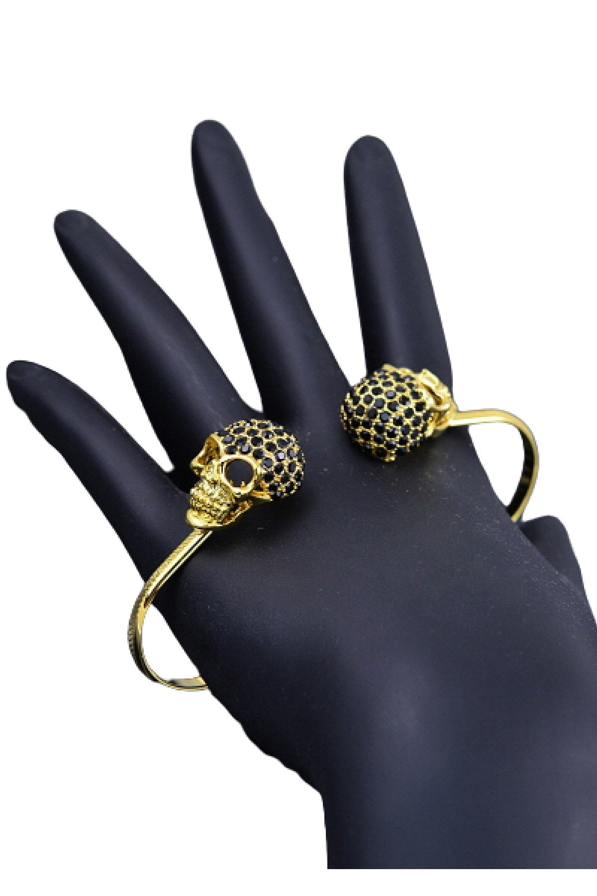 A stylish studded skull hand bracelet featuring double plated skulls, flexible design, and intricate detailing, perfect for edgy fashion lovers.