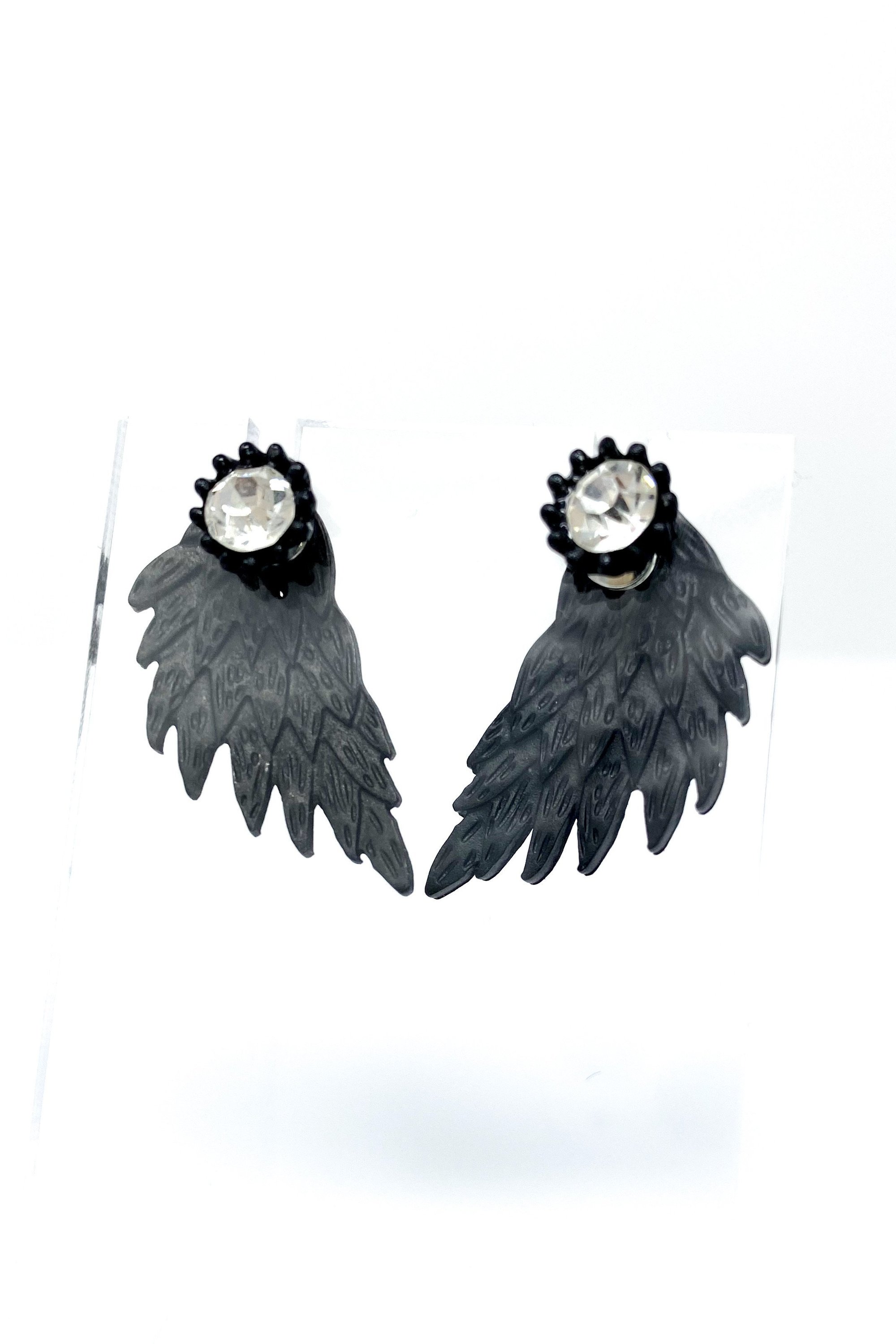 A pair of 420 Wingz Earrings featuring a unique wing design with a diamond accent, available in gold, silver, and black colors.