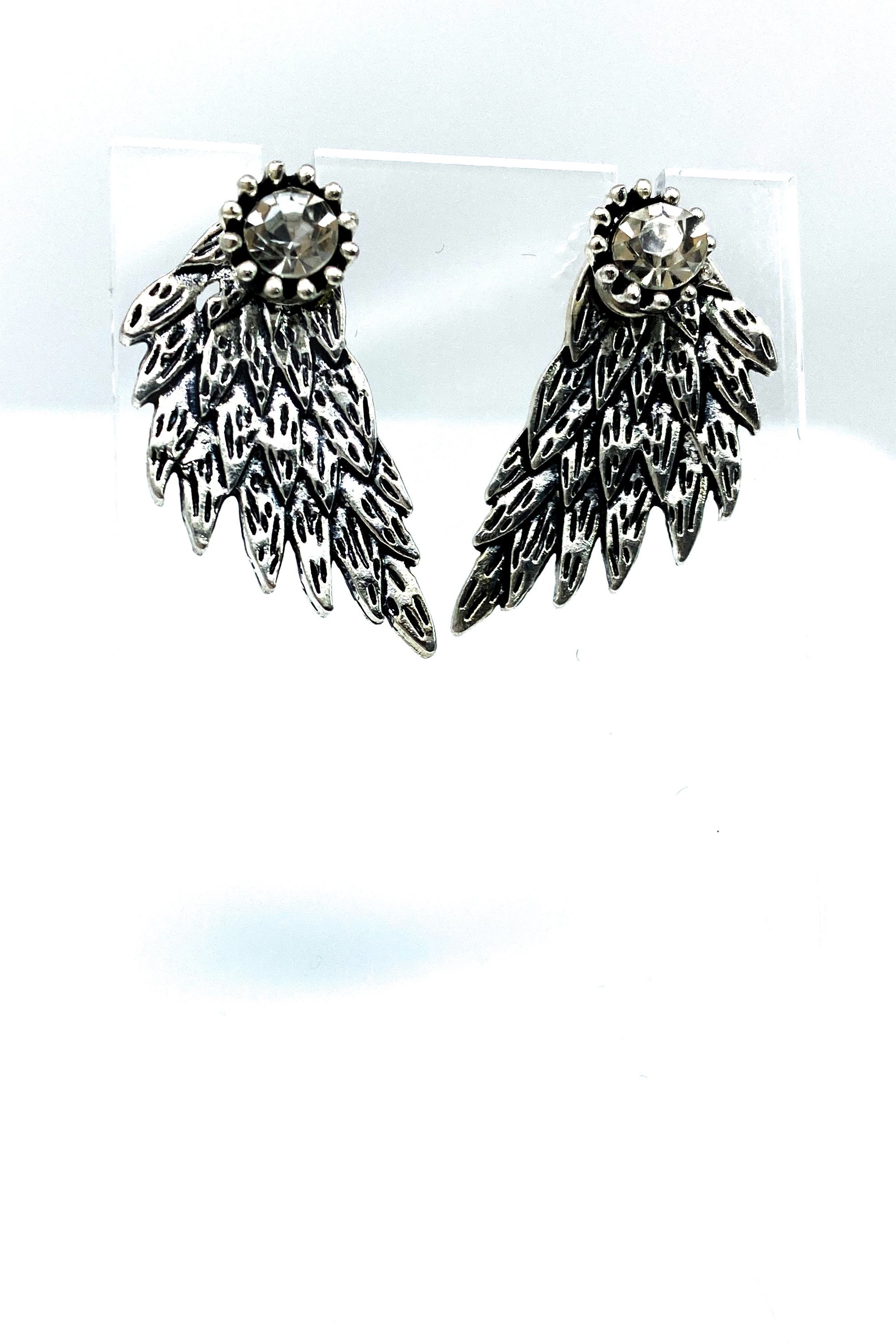 A pair of 420 Wingz Earrings featuring a unique wing design with a diamond accent, available in gold, silver, and black colors.