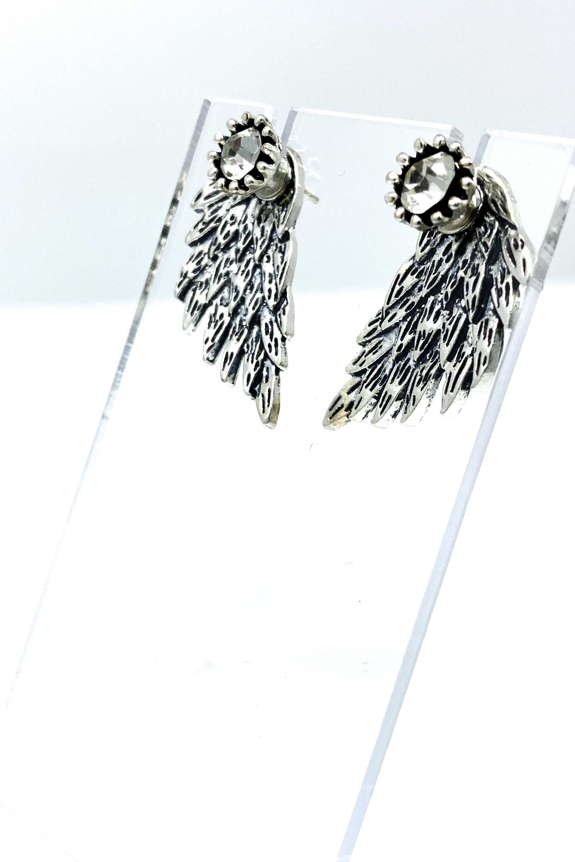 A pair of 420 Wingz Earrings featuring a unique wing design with a diamond accent, available in gold, silver, and black colors.