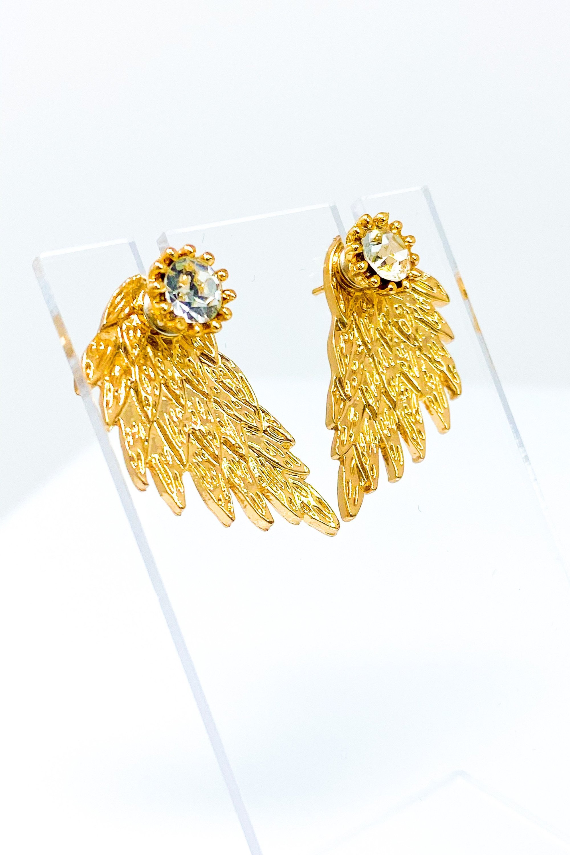 A pair of 420 Wingz Earrings featuring a unique wing design with a diamond accent, available in gold, silver, and black colors.