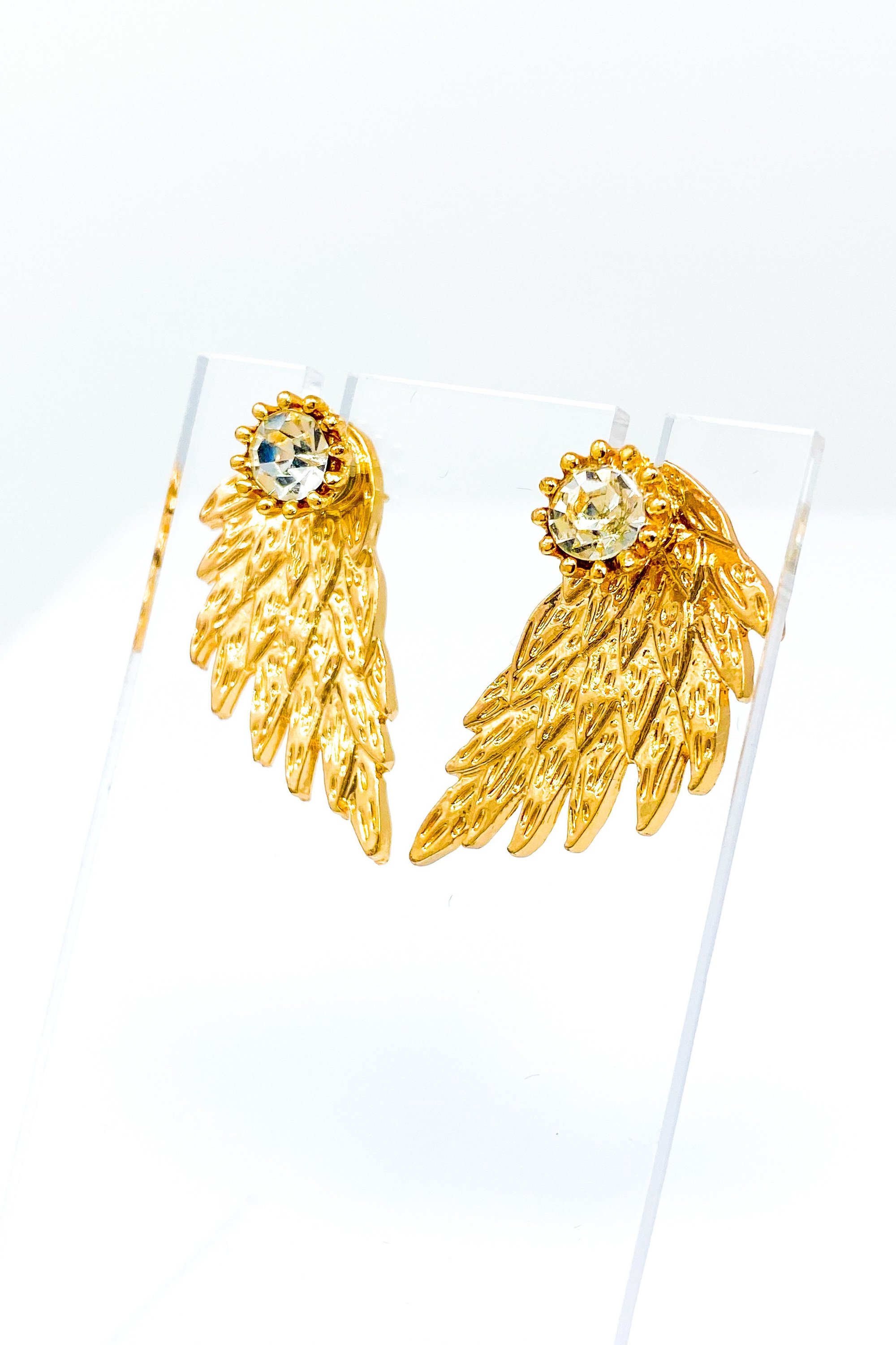 A pair of 420 Wingz Earrings featuring a unique wing design with a diamond accent, available in gold, silver, and black colors.