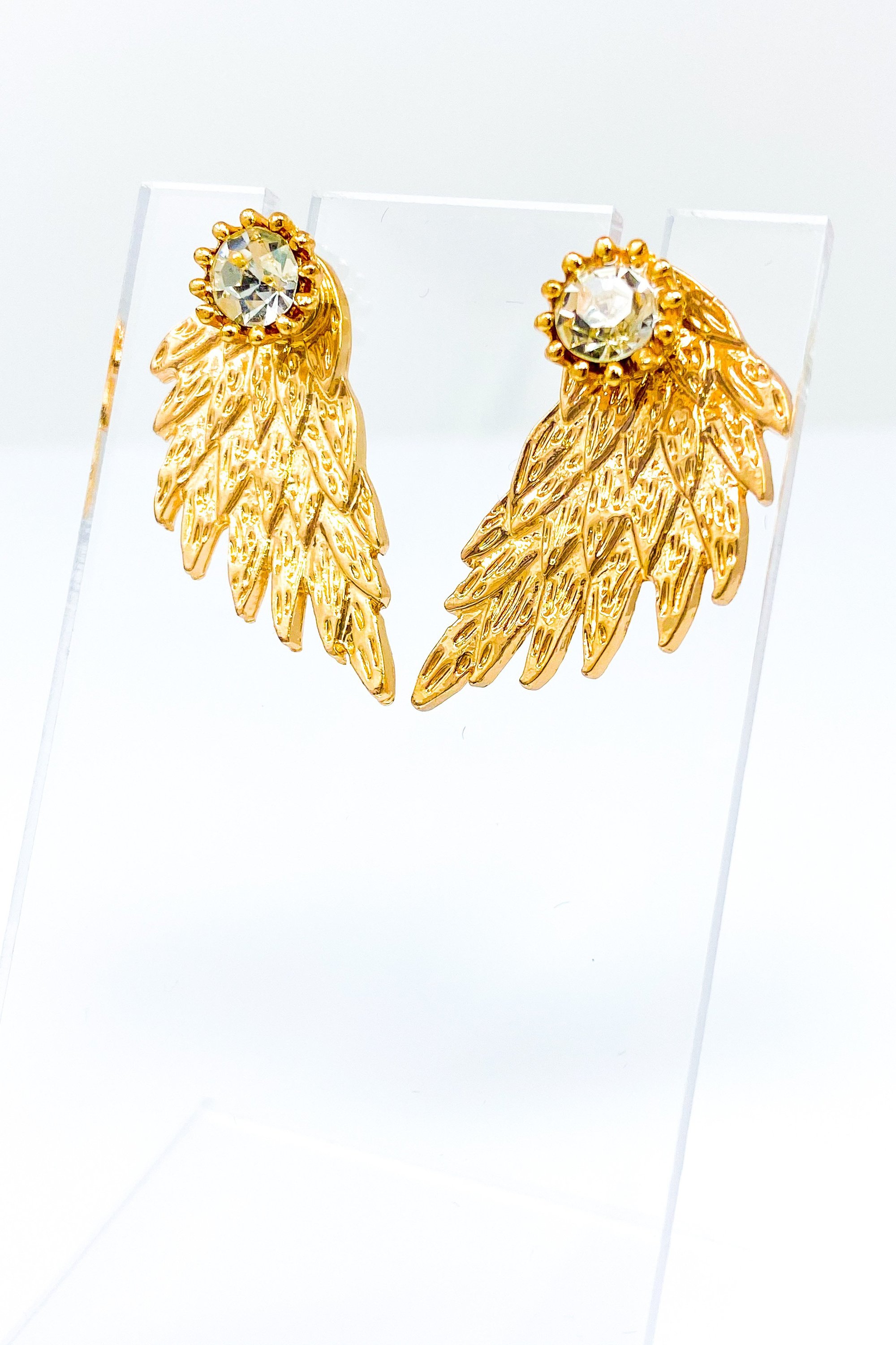 A pair of 420 Wingz Earrings featuring a unique wing design with a diamond accent, available in gold, silver, and black colors.