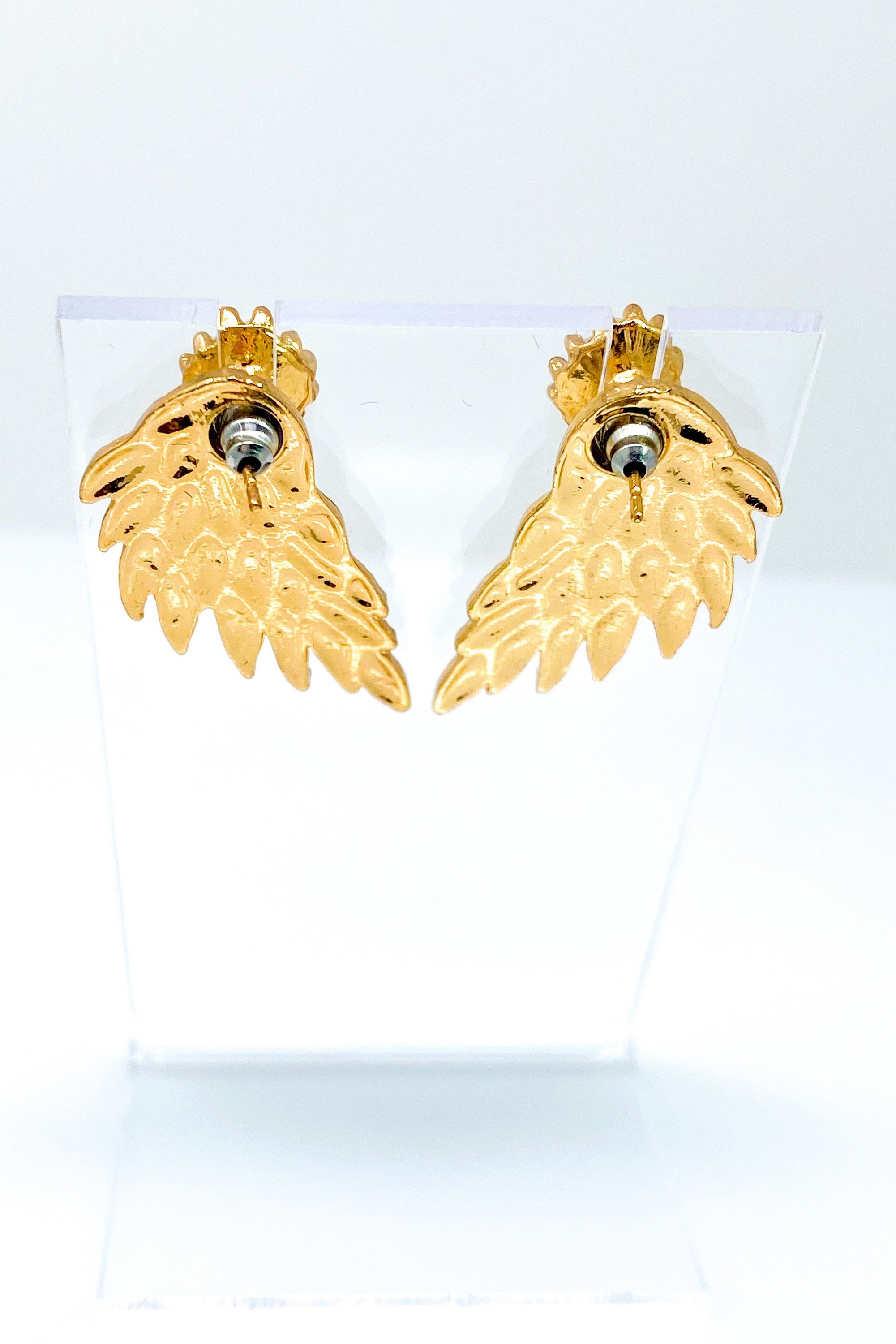 A pair of 420 Wingz Earrings featuring a unique wing design with a diamond accent, available in gold, silver, and black colors.