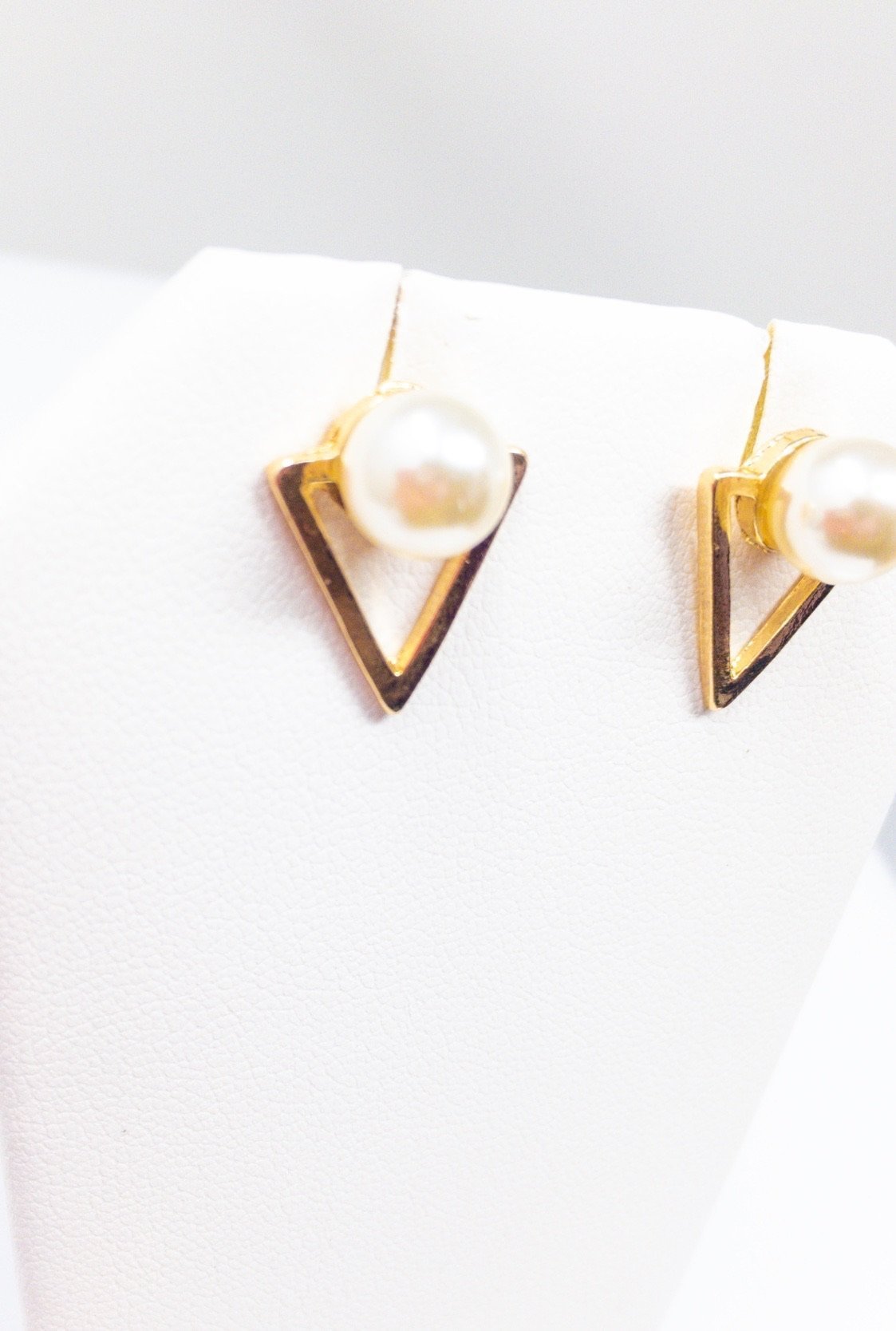 Aisha's classy stud earrings featuring a geometric design in gold with simulated pearls, perfect for any occasion.