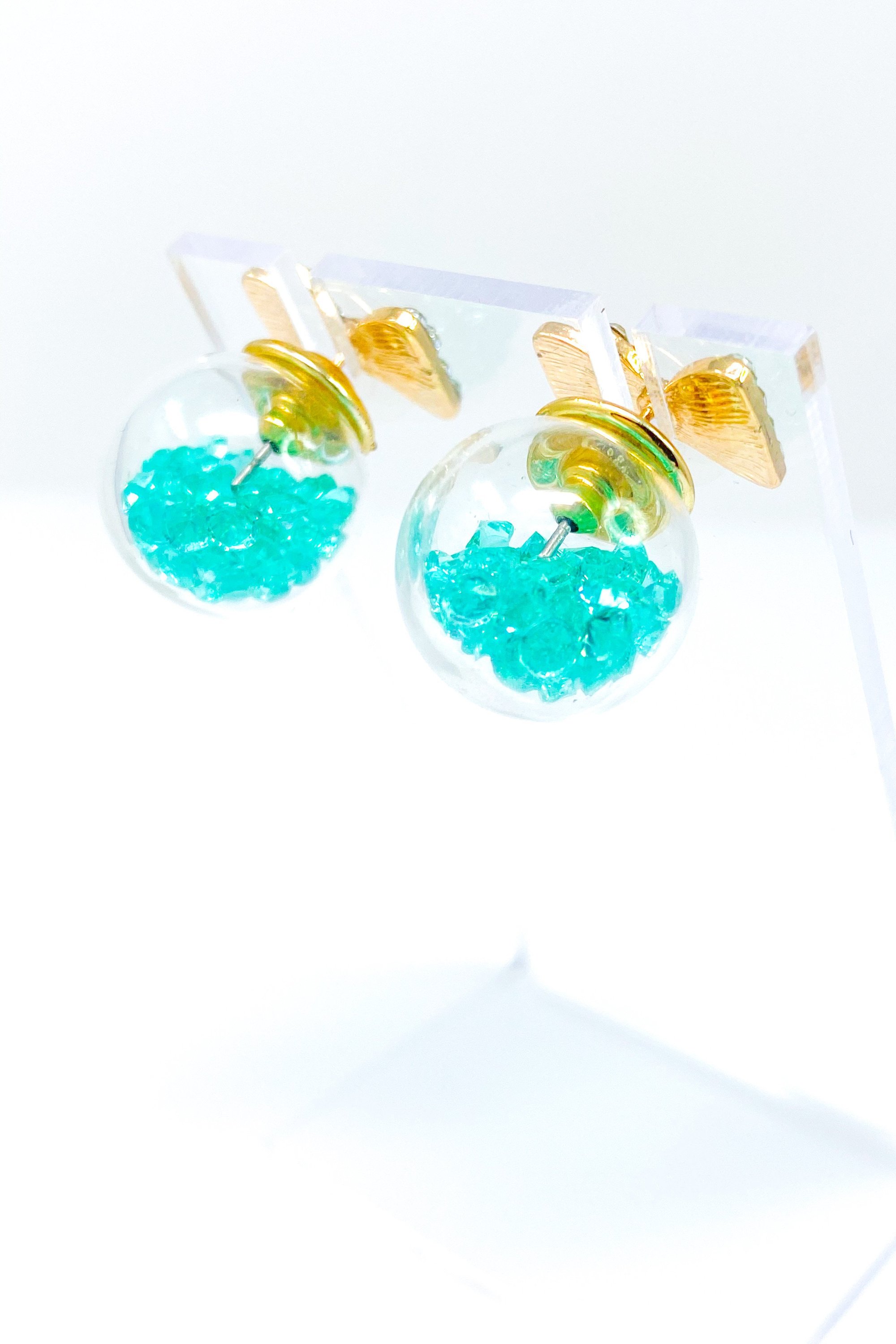 Bowtie Ice Studs featuring a sparkle bow tie design and moving ice ball, available in gold, blue, and green colors.