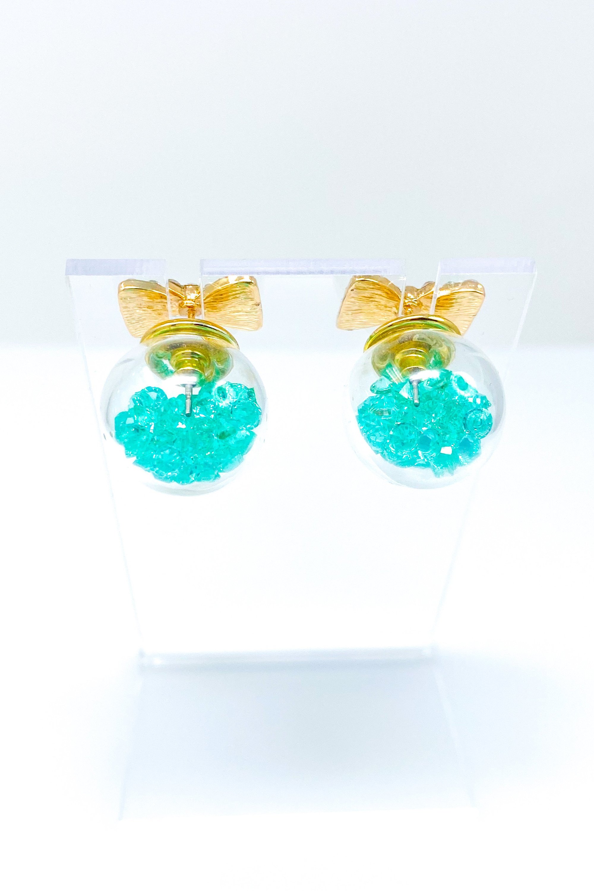 Bowtie Ice Studs featuring a sparkle bow tie design and moving ice ball, available in gold, blue, and green colors.