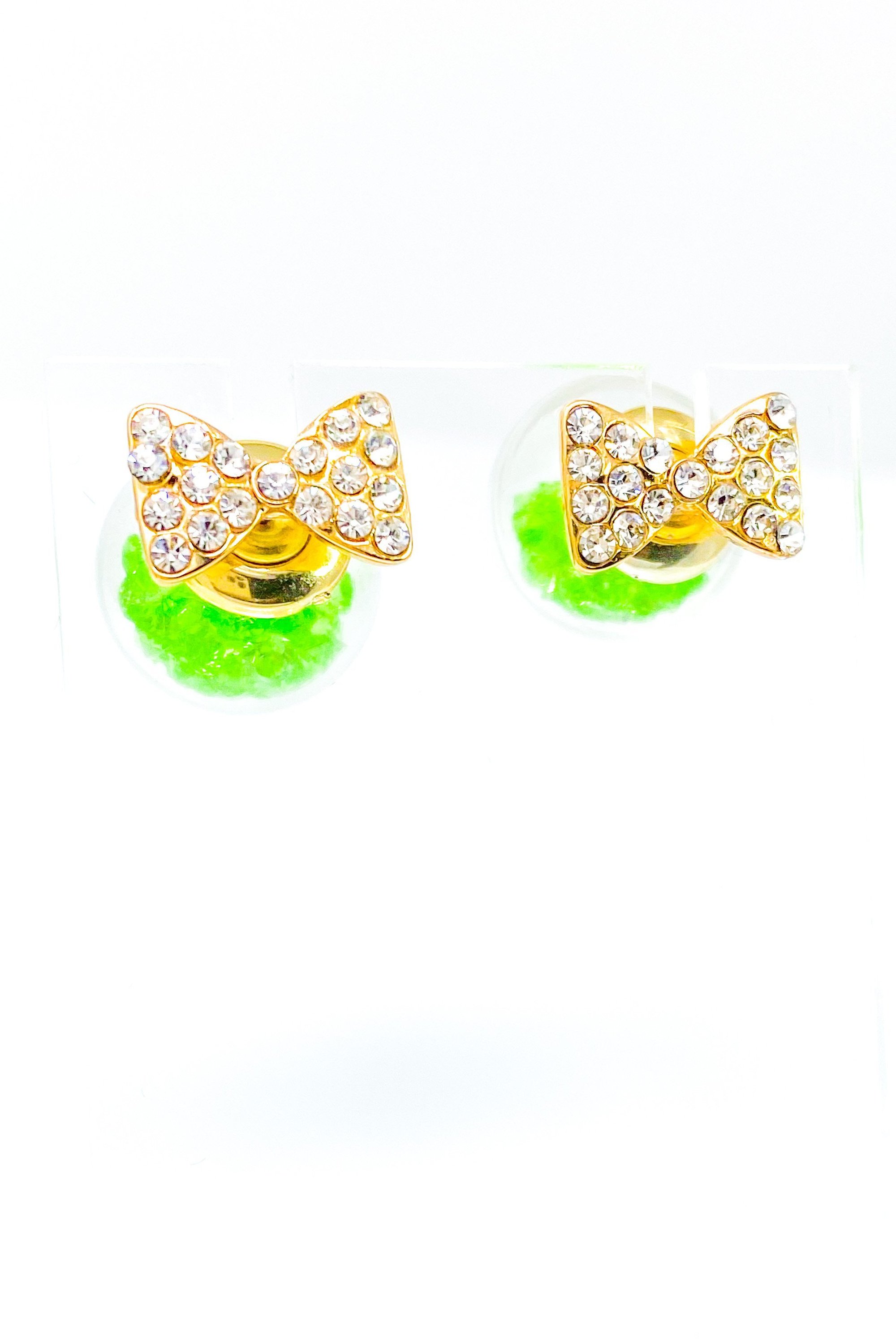 Bowtie Ice Studs featuring a sparkle bow tie design and moving ice ball, available in gold, blue, and green colors.