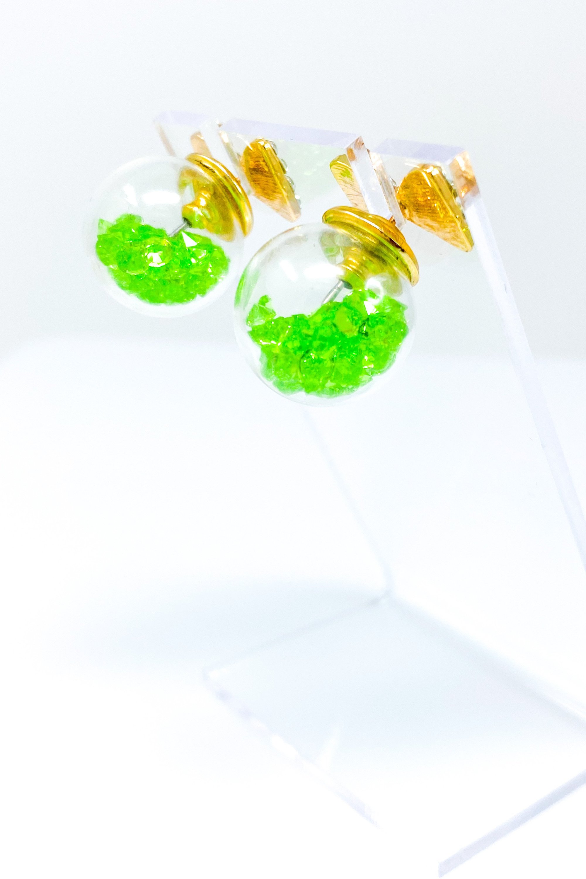 Bowtie Ice Studs featuring a sparkle bow tie design and moving ice ball, available in gold, blue, and green colors.