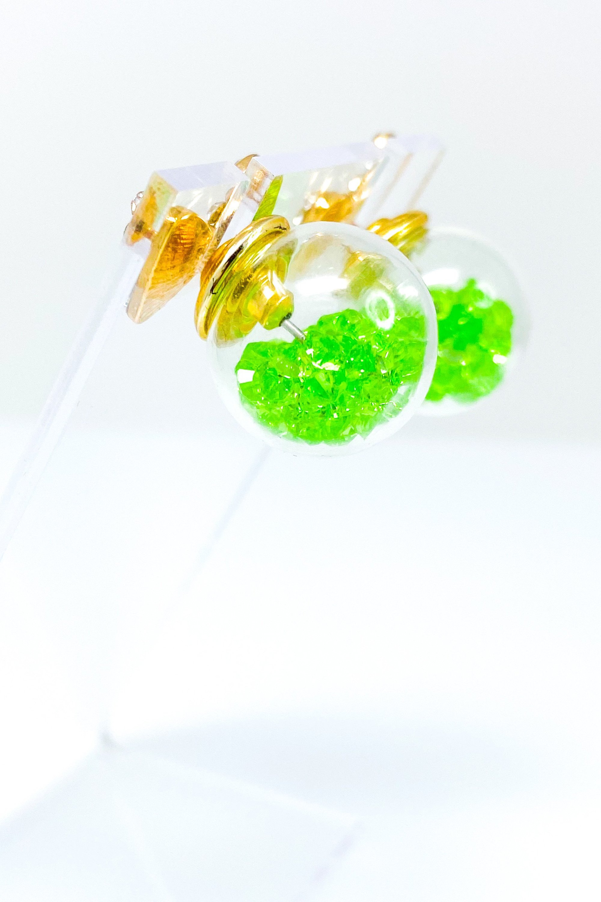 Bowtie Ice Studs featuring a sparkle bow tie design and moving ice ball, available in gold, blue, and green colors.