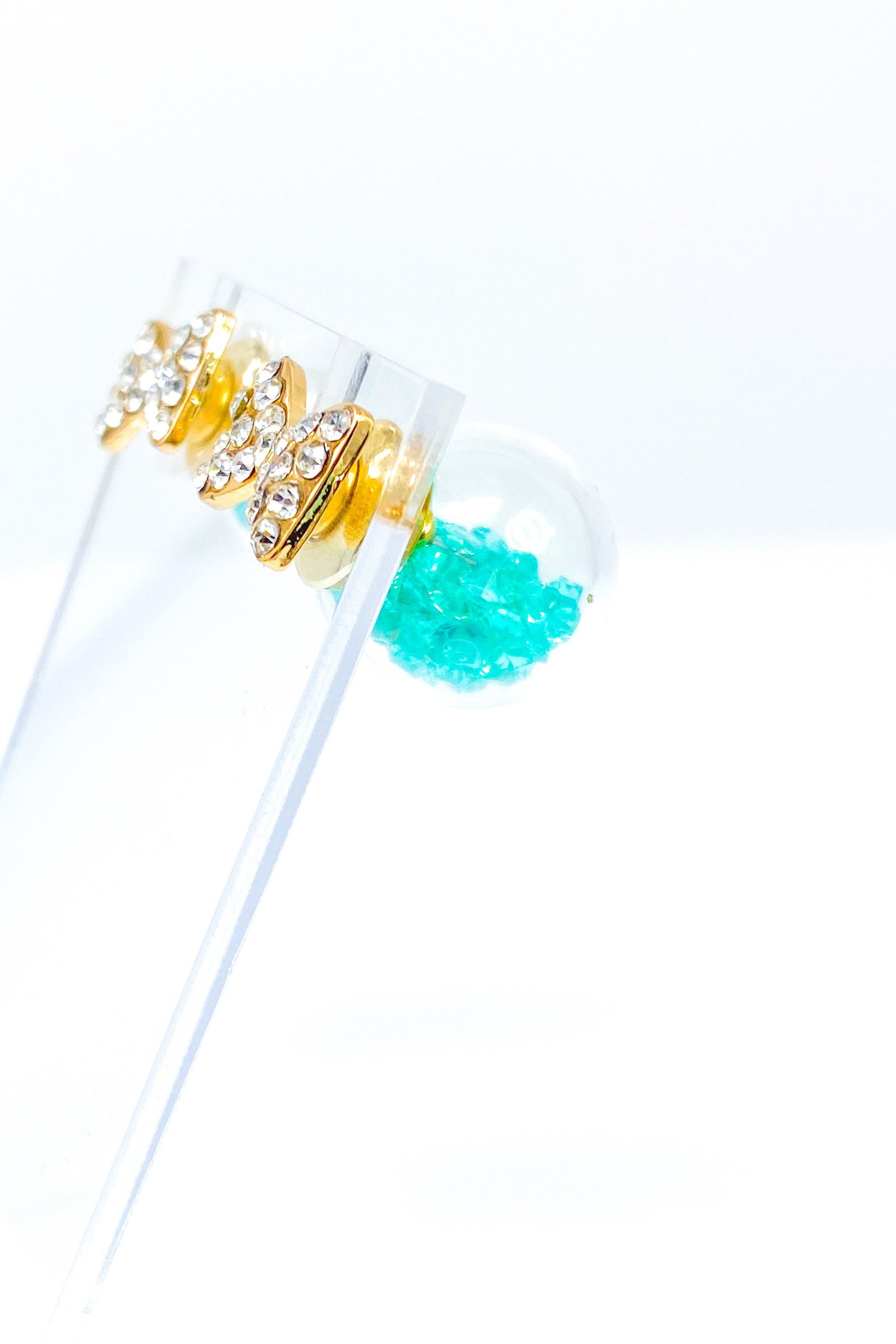 Bowtie Ice Studs featuring a sparkle bow tie design and moving ice ball, available in gold, blue, and green colors.