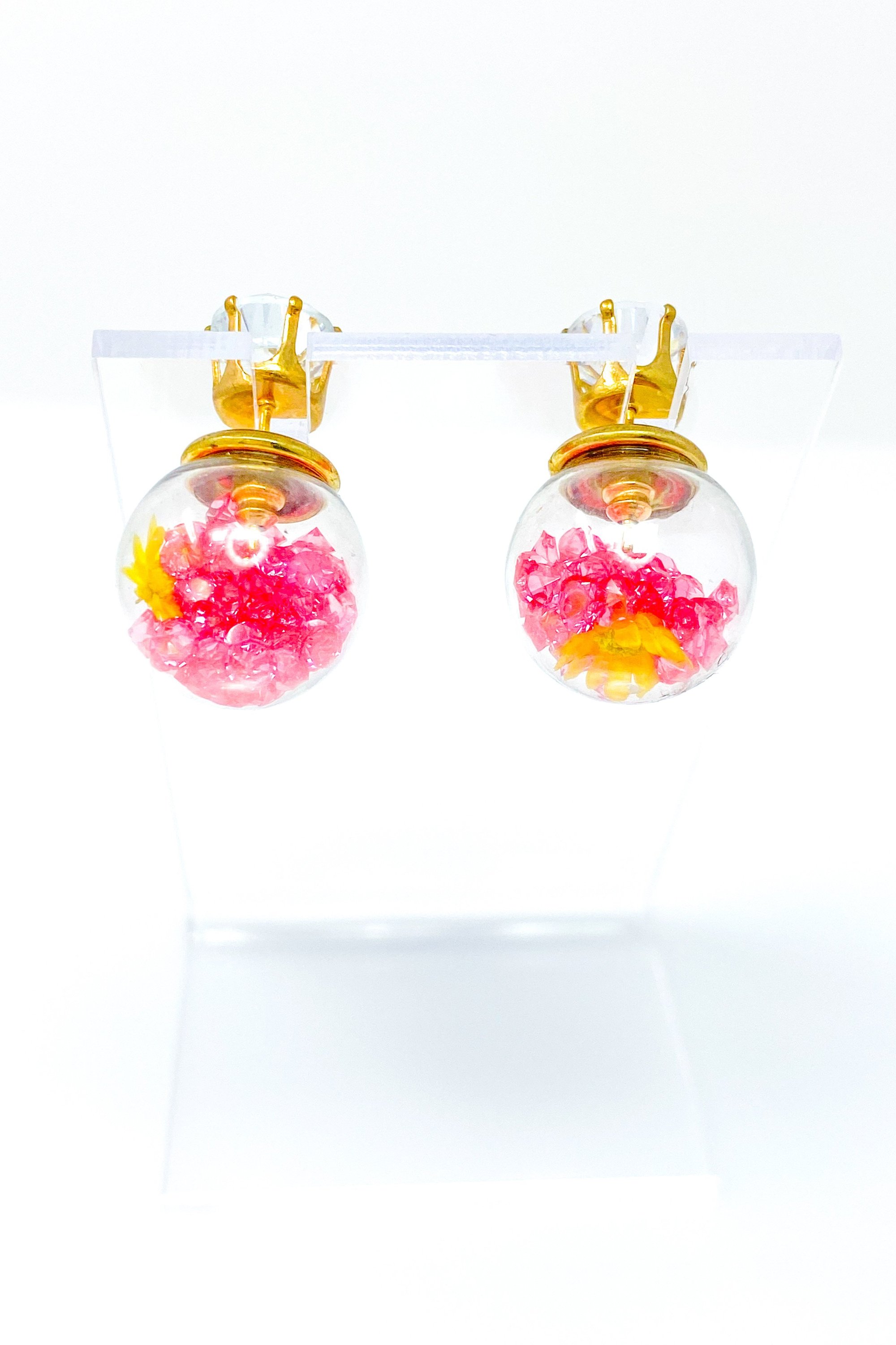 Perennial Ice Studs featuring handcrafted moving flowers and a plastique ice ball design in gold and multicolored options.