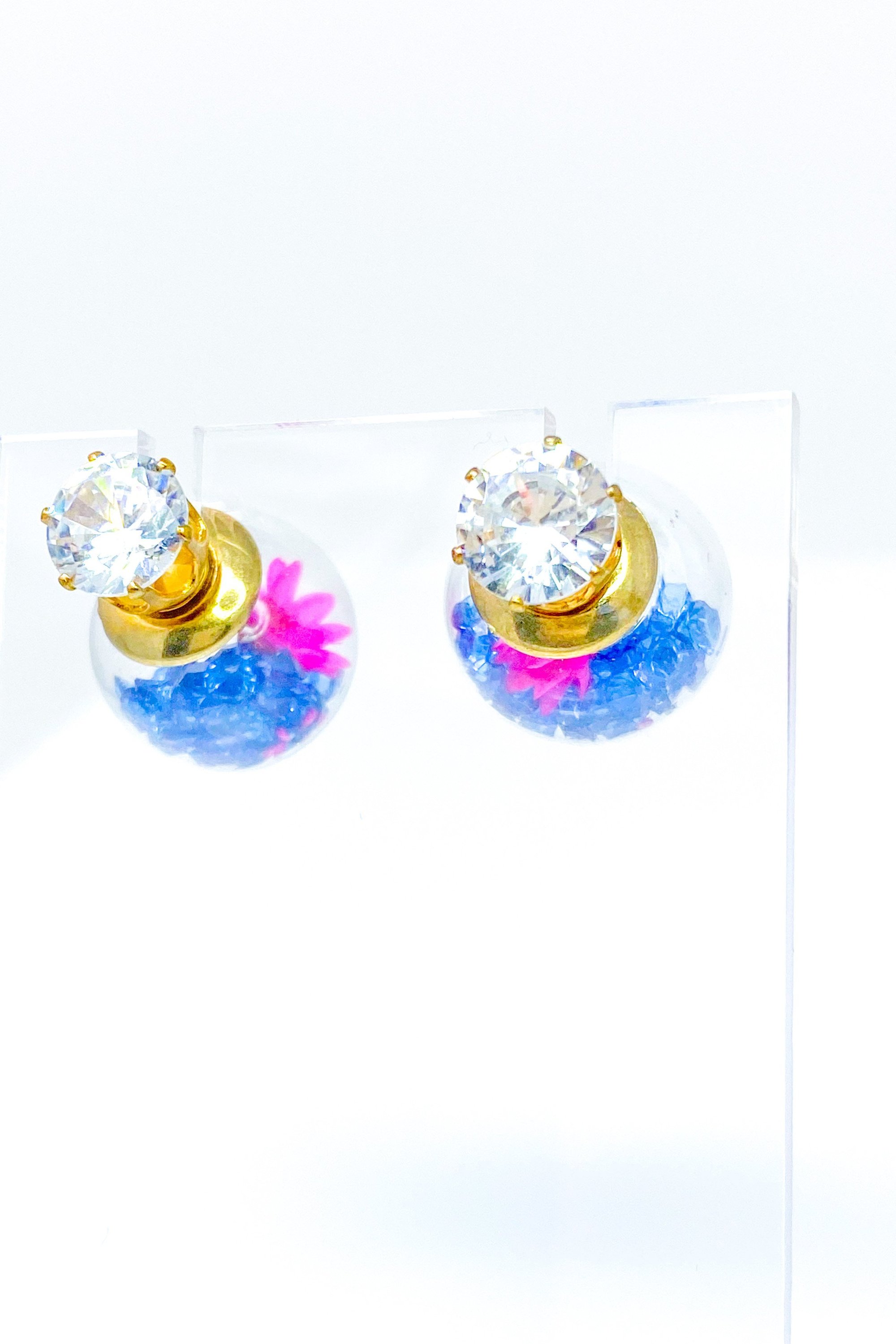 Perennial Ice Studs featuring handcrafted moving flowers and a plastique ice ball design in gold and multicolored options.