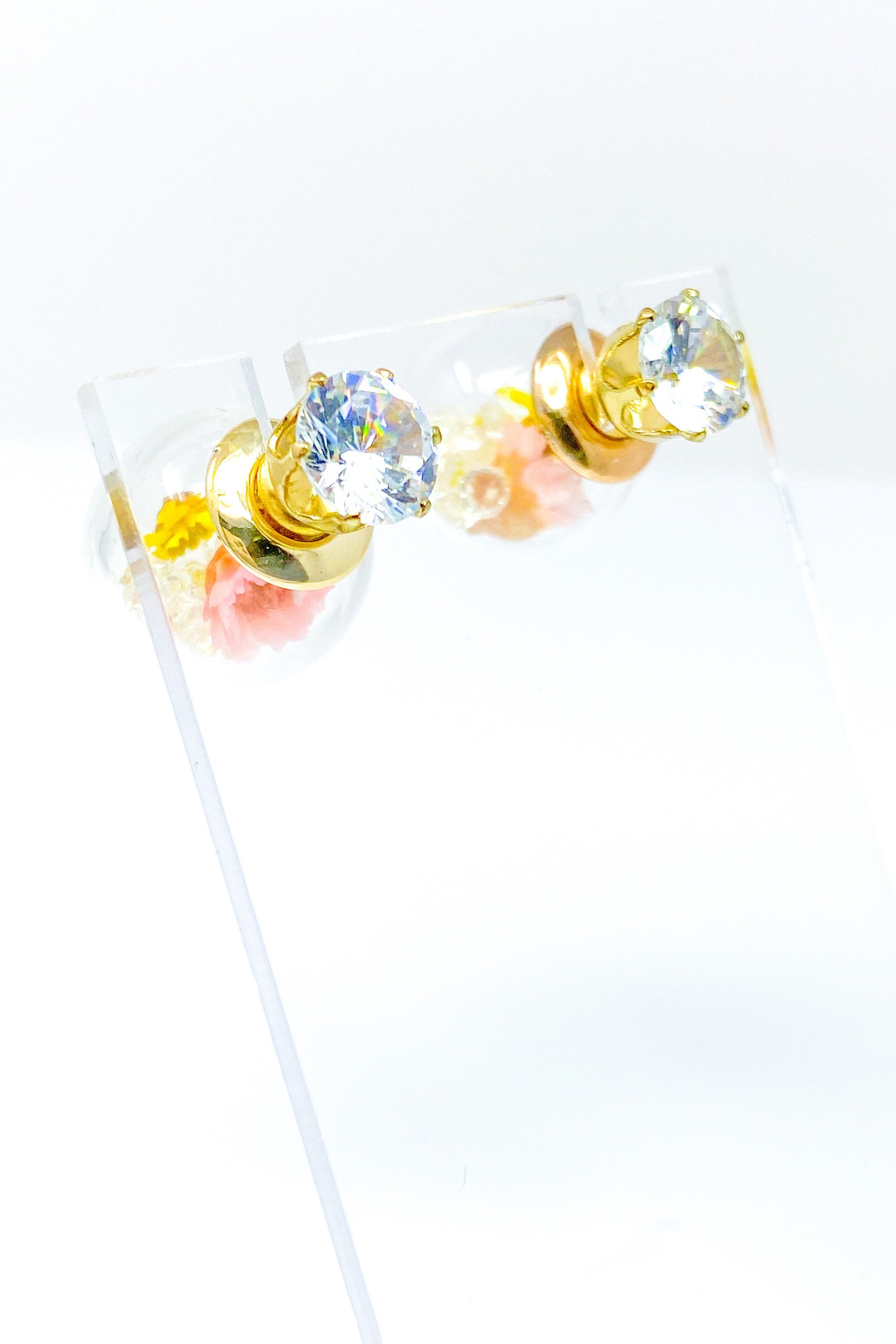 Perennial Ice Studs featuring handcrafted moving flowers and a plastique ice ball design in gold and multicolored options.