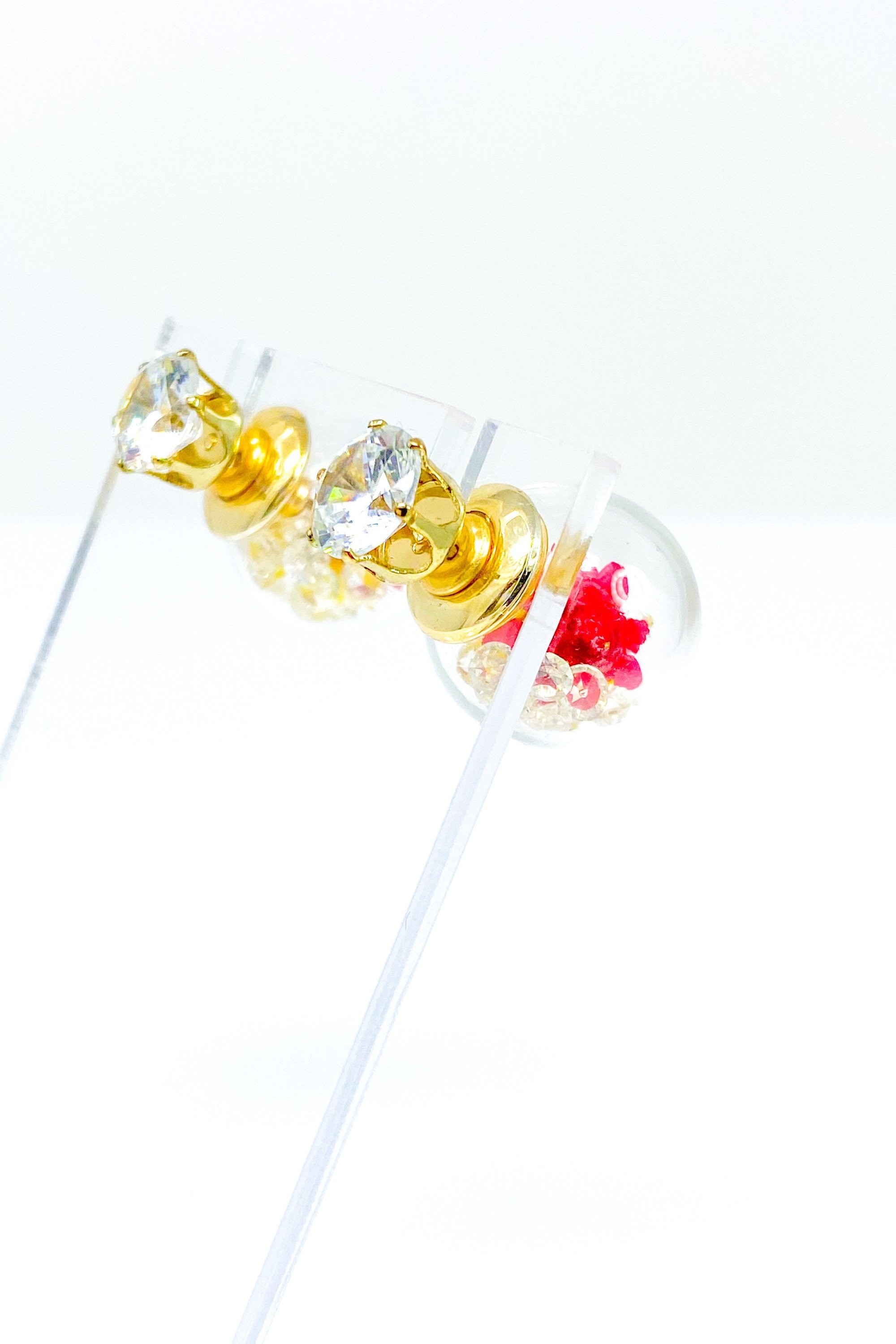 Perennial Ice Studs featuring handcrafted moving flowers and a plastique ice ball design in gold and multicolored options.