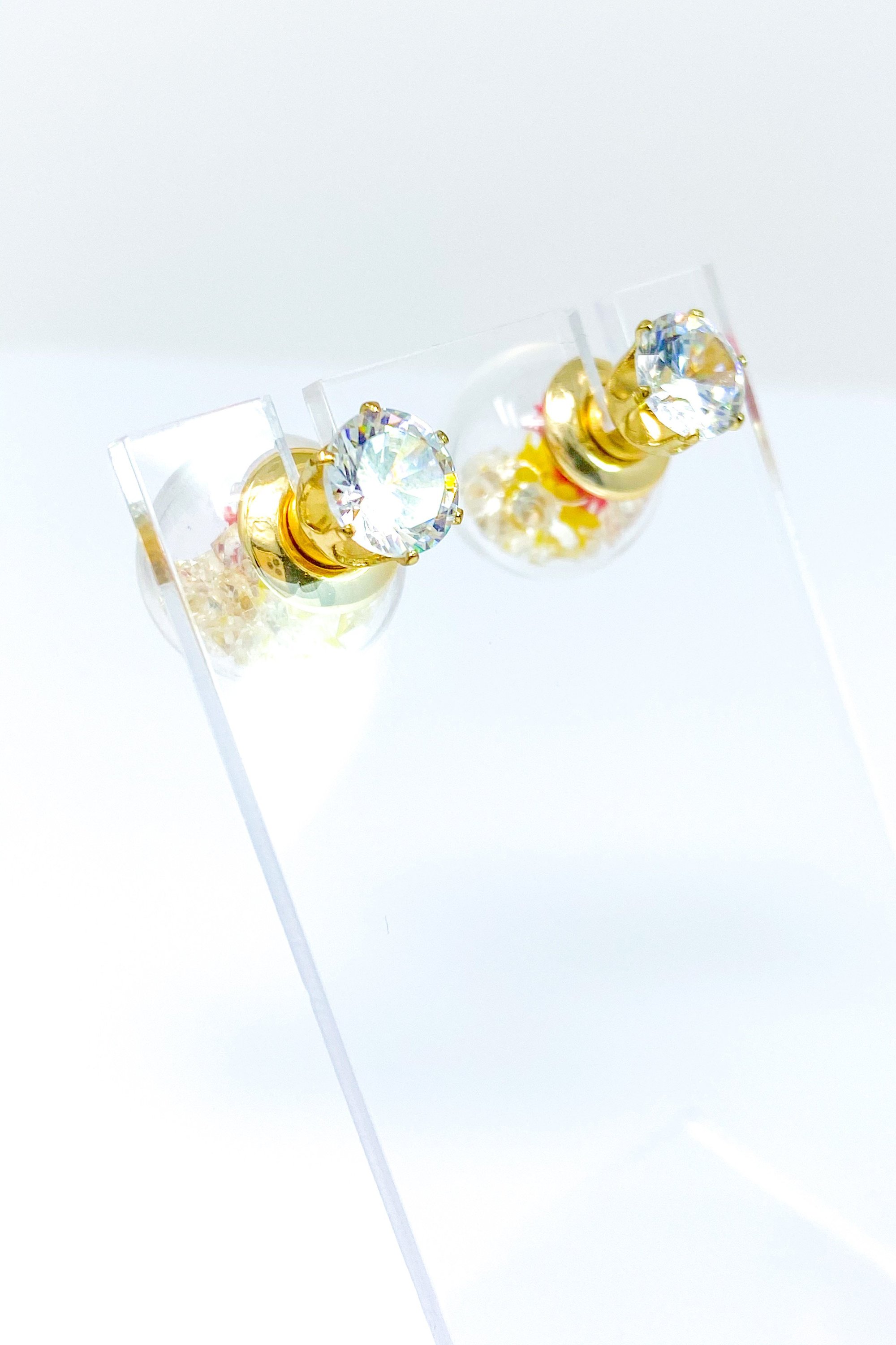 Perennial Ice Studs featuring handcrafted moving flowers and a plastique ice ball design in gold and multicolored options.