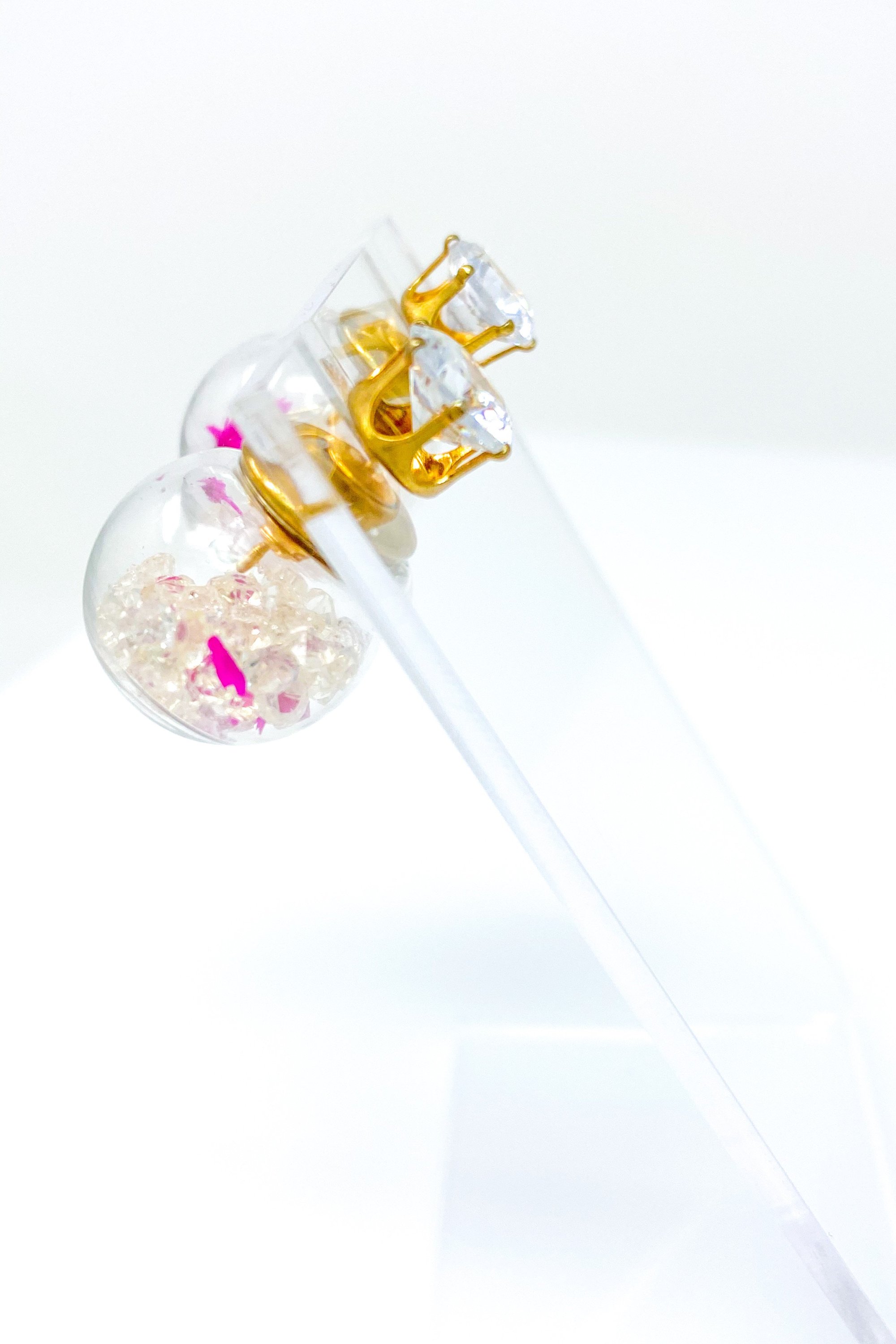 Perennial Ice Studs featuring handcrafted moving flowers and a plastique ice ball design in gold and multicolored options.