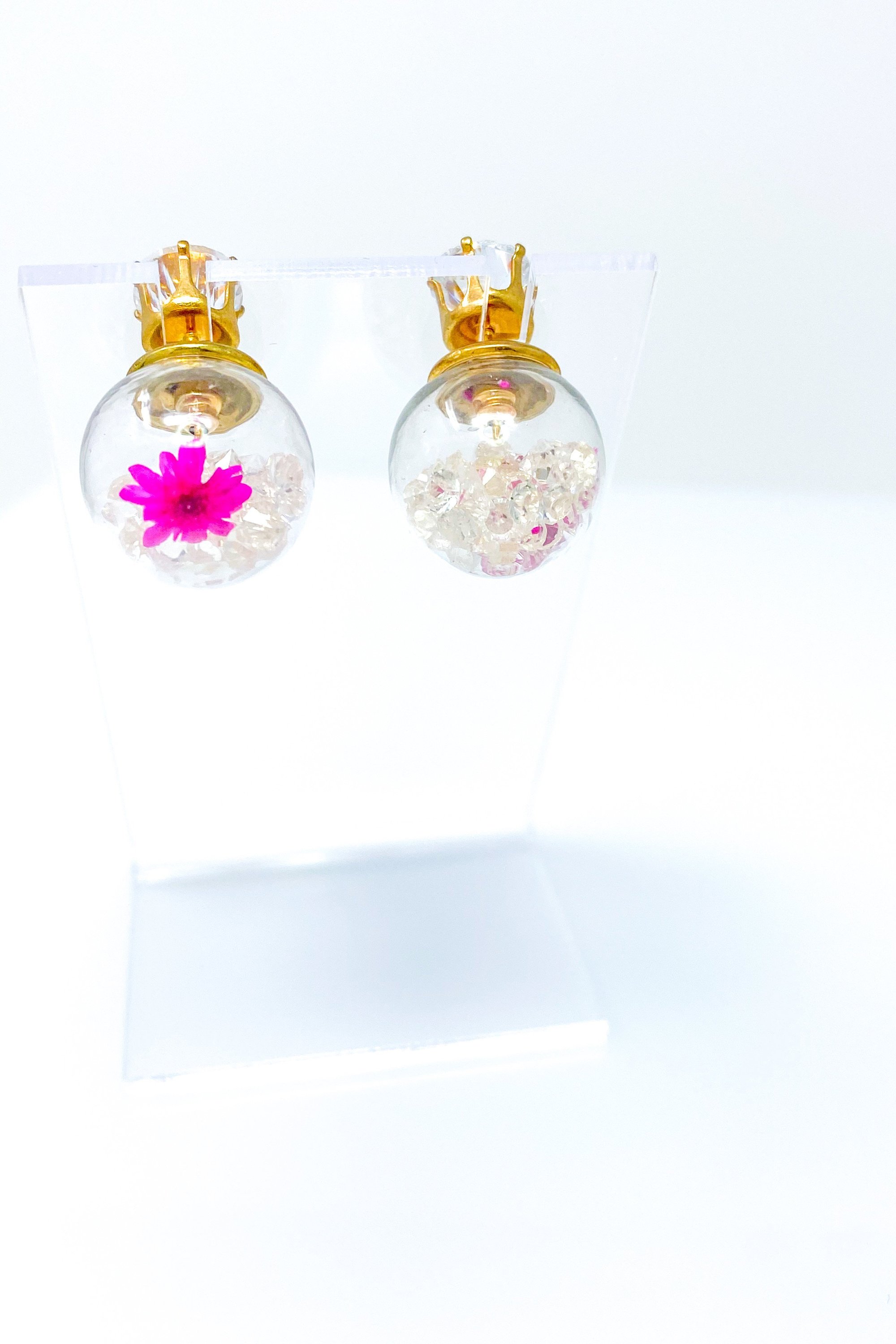 Perennial Ice Studs featuring handcrafted moving flowers and a plastique ice ball design in gold and multicolored options.