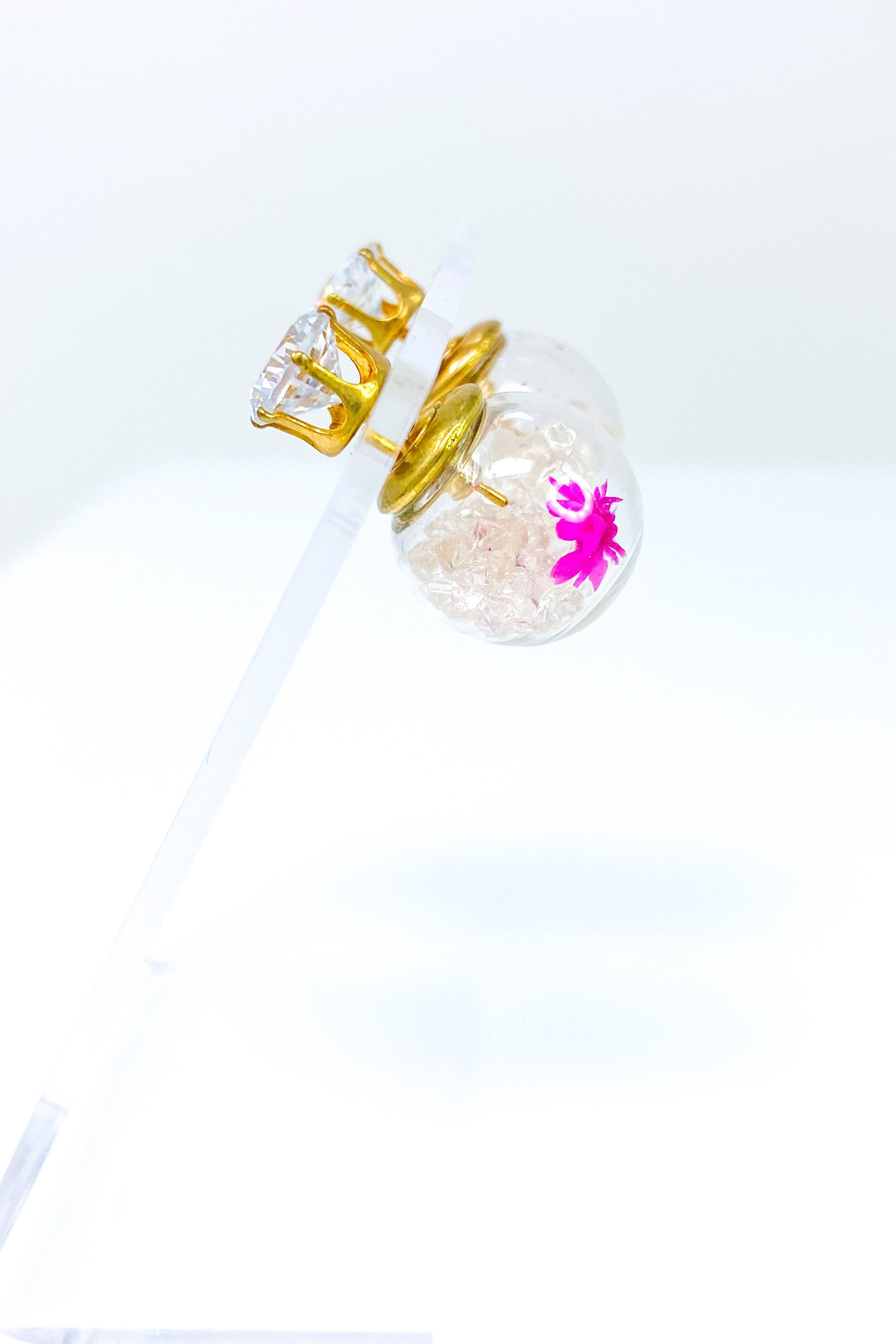 Perennial Ice Studs featuring handcrafted moving flowers and a plastique ice ball design in gold and multicolored options.