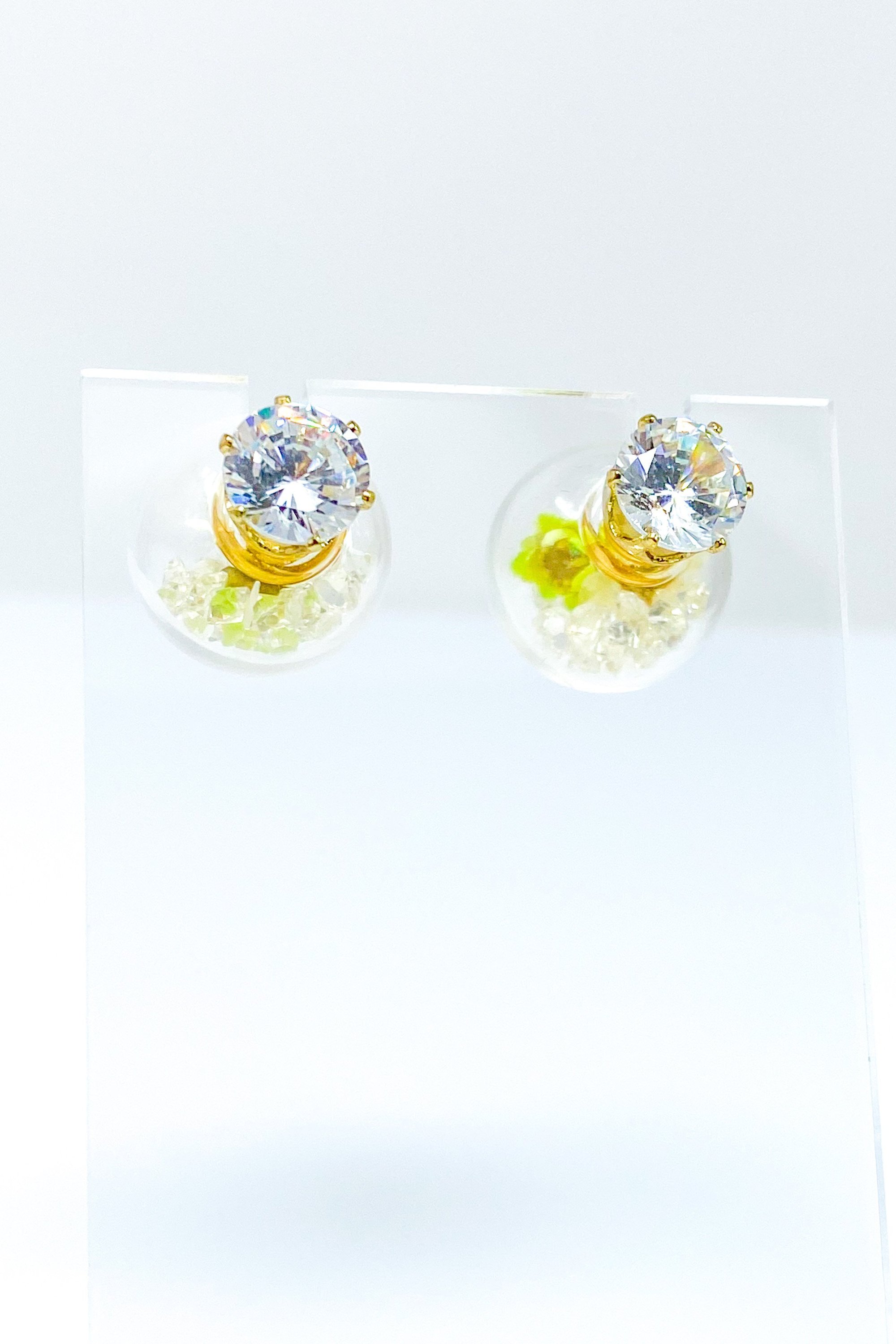 Perennial Ice Studs featuring handcrafted moving flowers and a plastique ice ball design in gold and multicolored options.