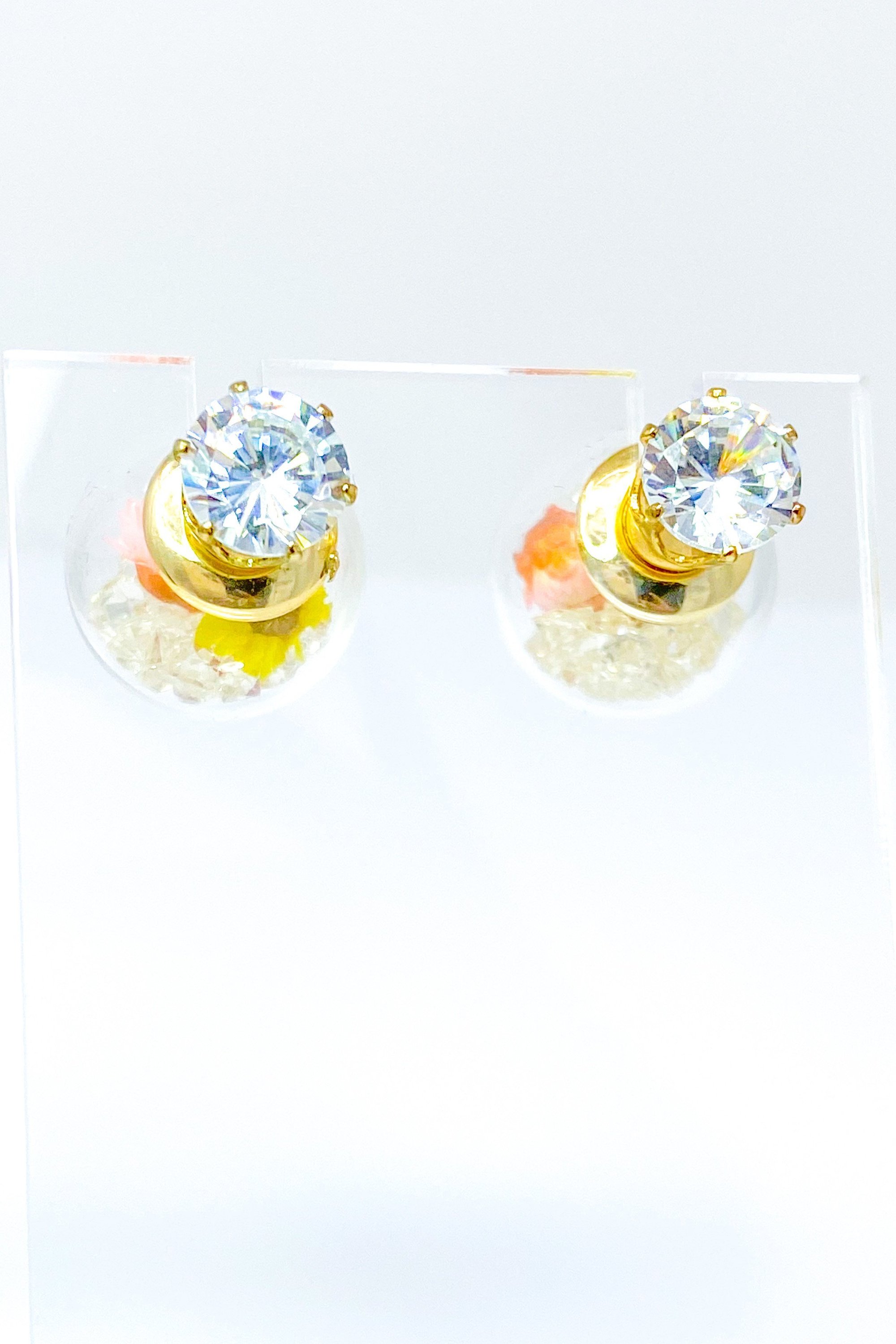 Perennial Ice Studs featuring handcrafted moving flowers and a plastique ice ball design in gold and multicolored options.