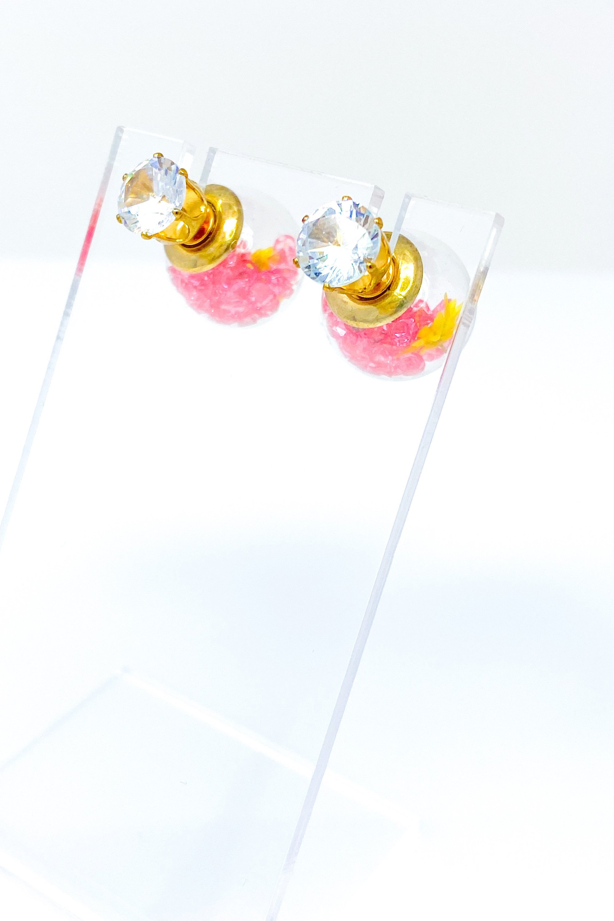 Perennial Ice Studs featuring handcrafted moving flowers and a plastique ice ball design in gold and multicolored options.