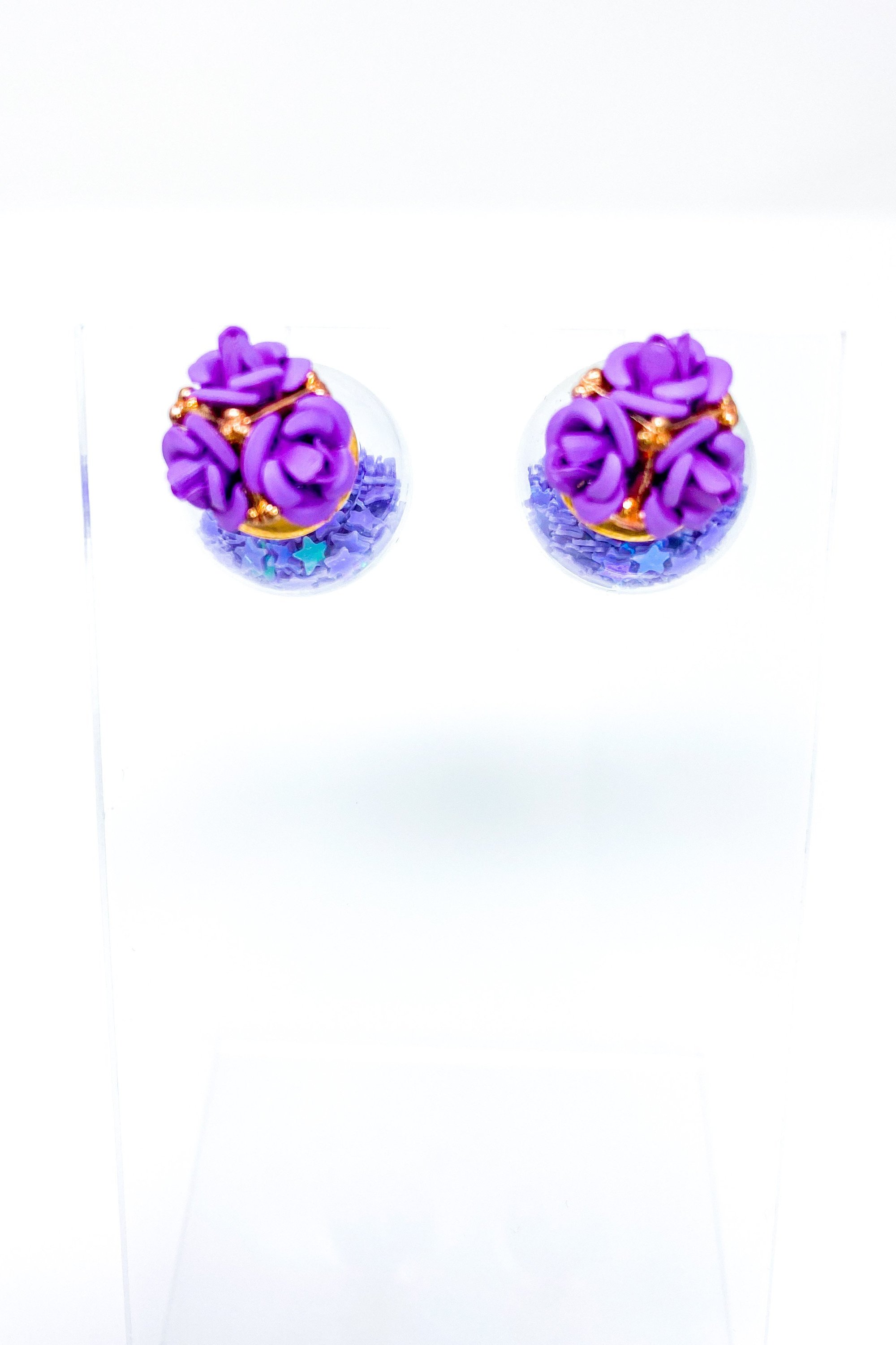 Star Blossom Studs featuring a flower trio design with iridescent stars in purple and pink colors, made from high-quality zinc alloy.