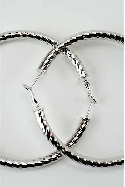 Large textured hoop earrings with omega closure, showcasing a stylish design.