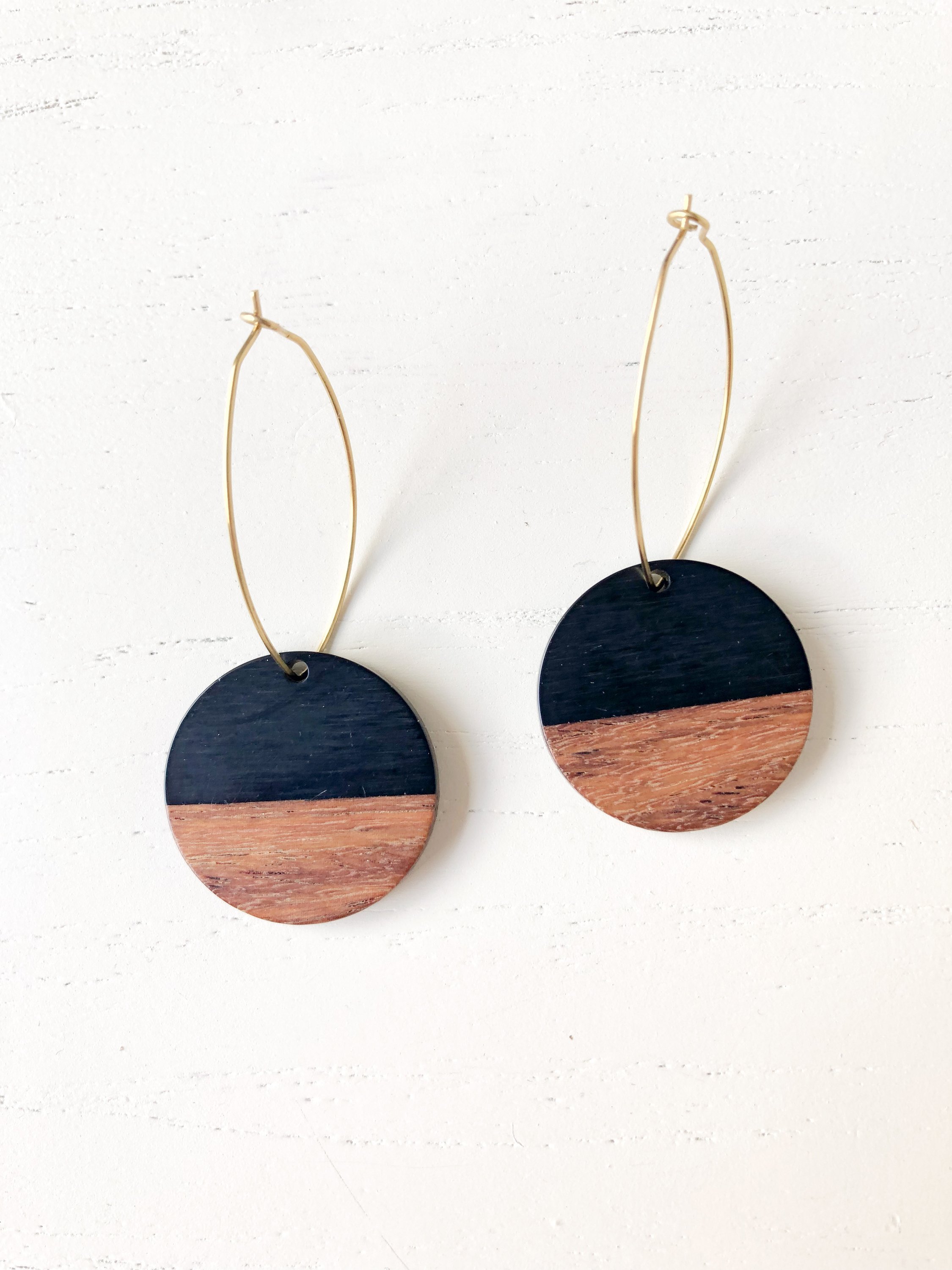 Midcentury Rounds - Black earrings featuring nickel-free brass with wood and resin details, showcasing a modern design.