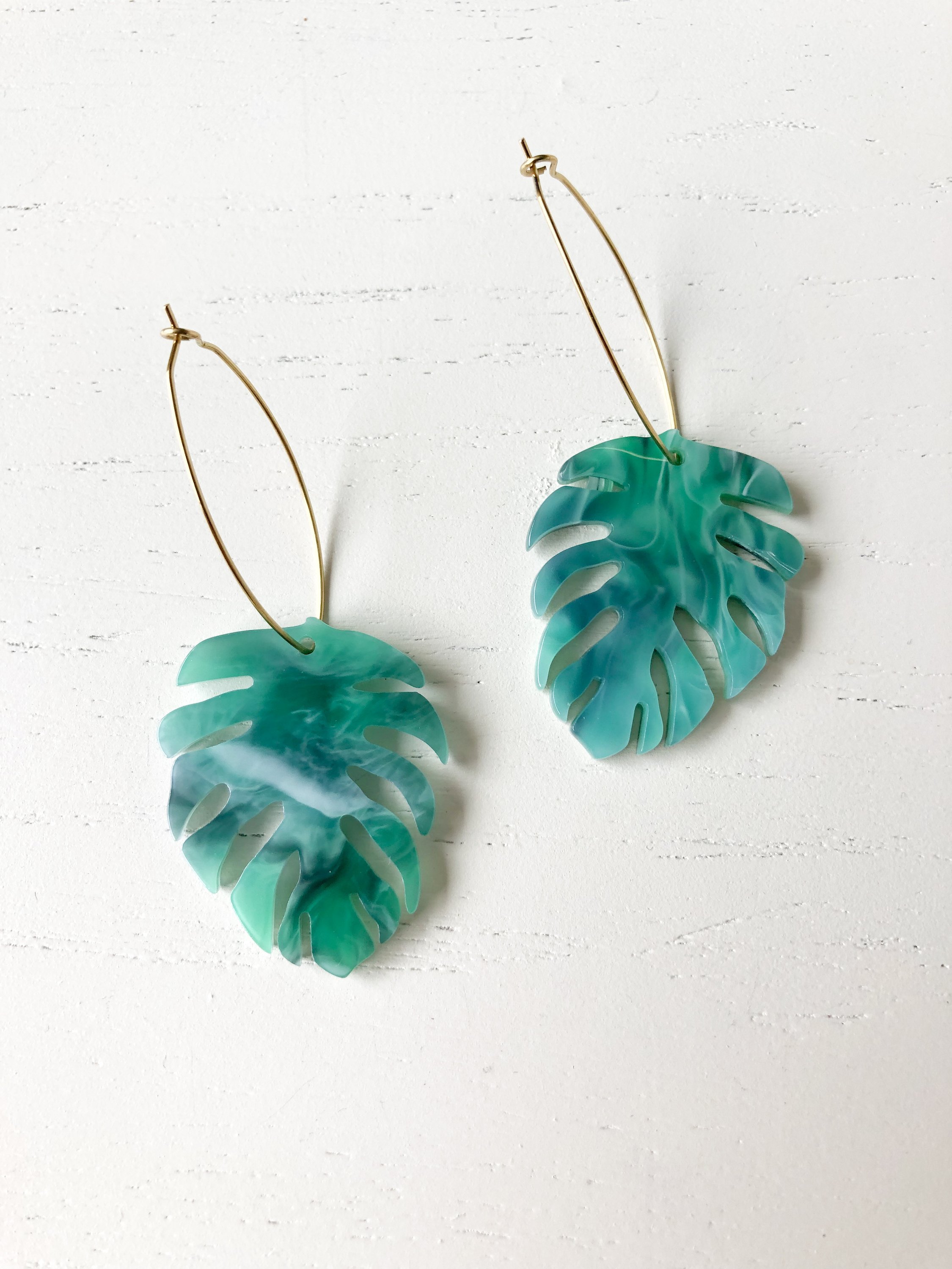 Stylish Monstera earrings featuring green resin detail on nickel-free brass hoops, measuring 2.5 inches in length.