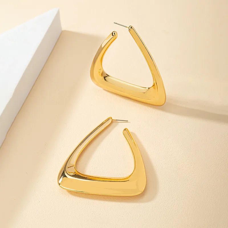 A pair of elegant triangular gold earrings showcasing a modern design, perfect for any occasion.