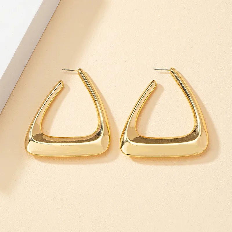 A pair of elegant triangular gold earrings showcasing a modern design, perfect for any occasion.