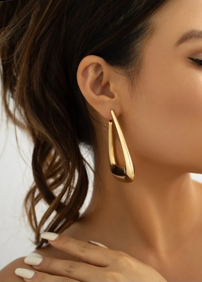 A pair of elegant triangular gold earrings showcasing a modern design, perfect for any occasion.