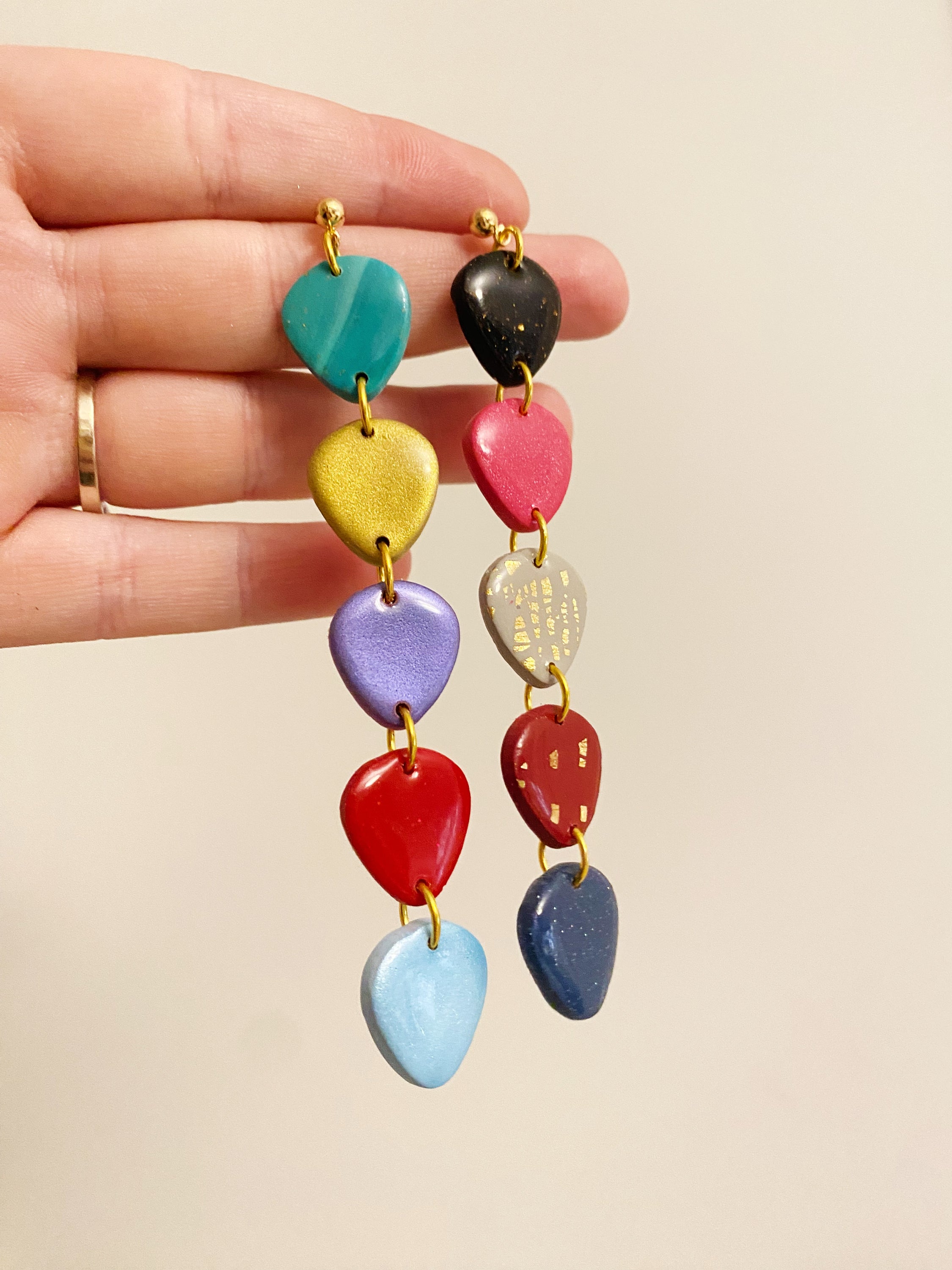 Handmade polymer clay earrings inspired by TS Era’s Tour, featuring vibrant colors and unique guitar pick designs.