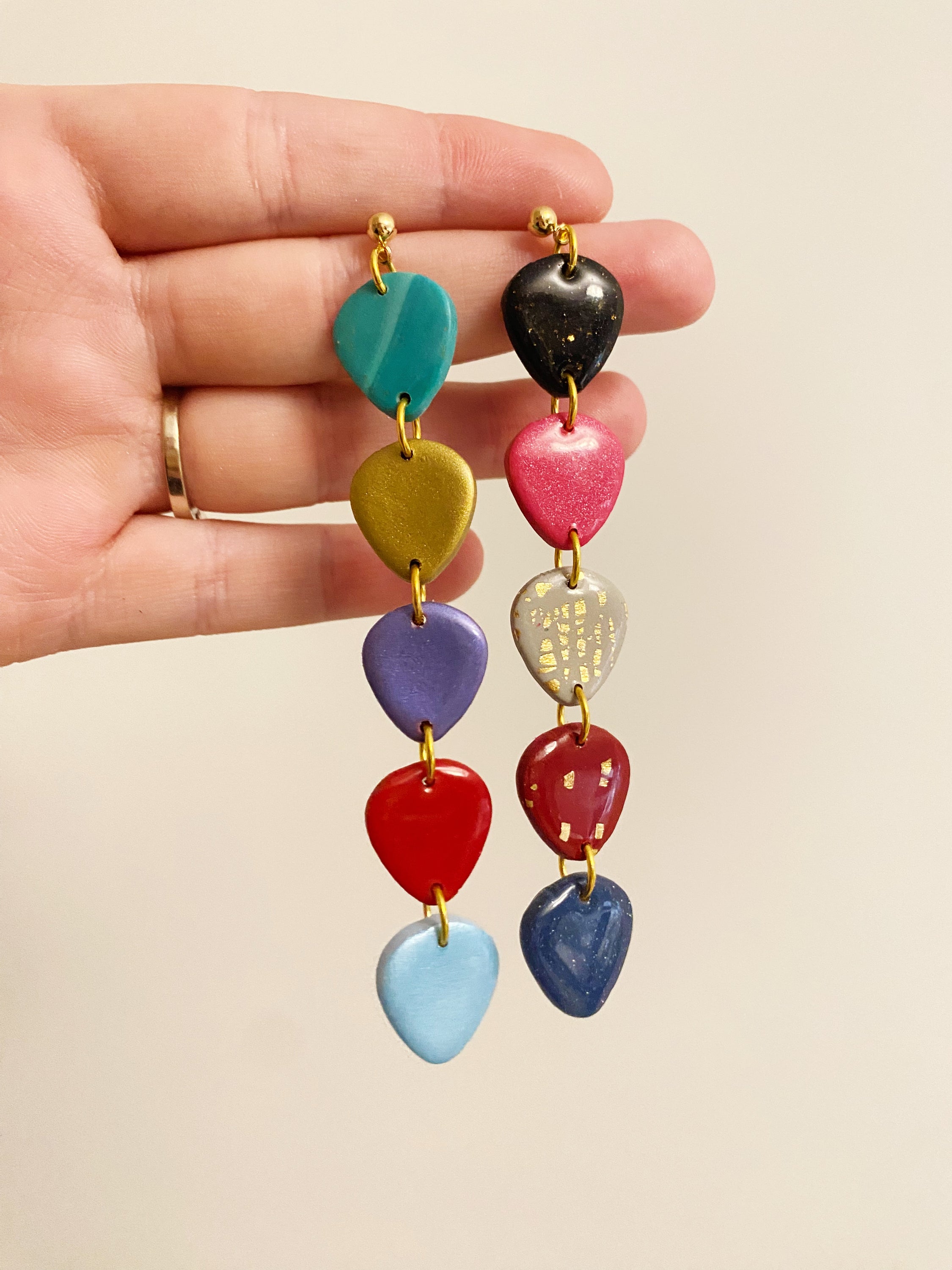 Handmade polymer clay earrings inspired by TS Era’s Tour, featuring vibrant colors and unique guitar pick designs.