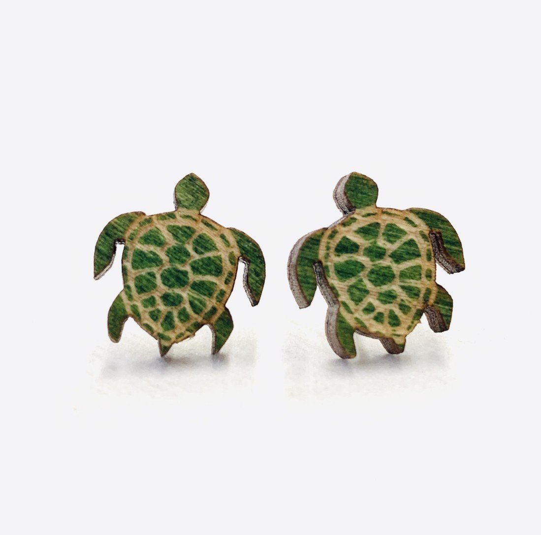 A pair of Turtle Stud Earrings made from sustainably sourced wood, featuring a playful turtle design with silver plated brass earstuds.