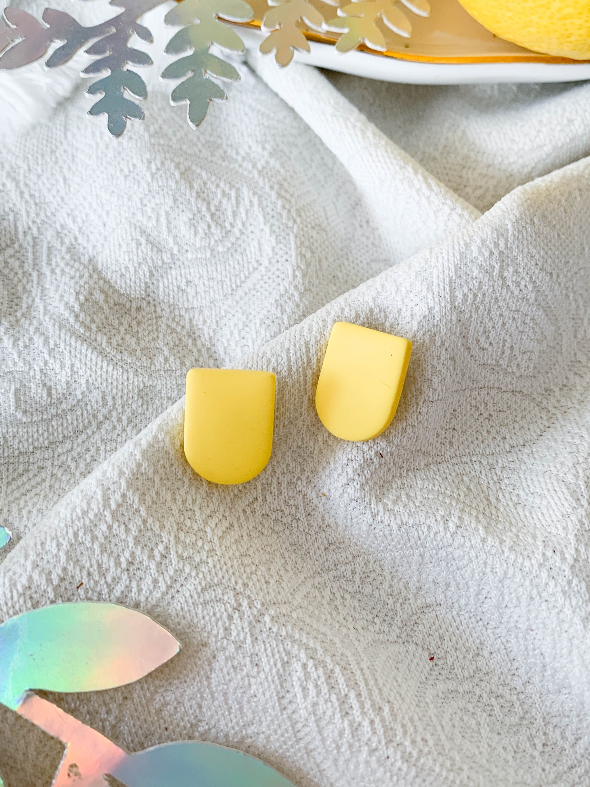 Ulma Lemon earrings featuring a playful lemon design with surgical steel posts for sensitive ears.