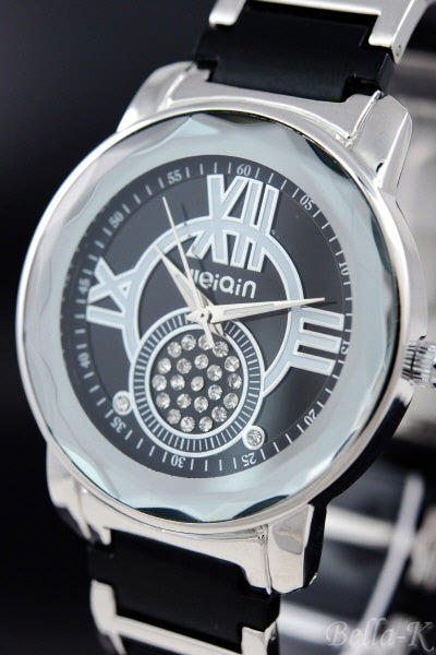 A stylish crystal studded case watch with a stainless steel back and fold over clasp, showcasing its elegant design.